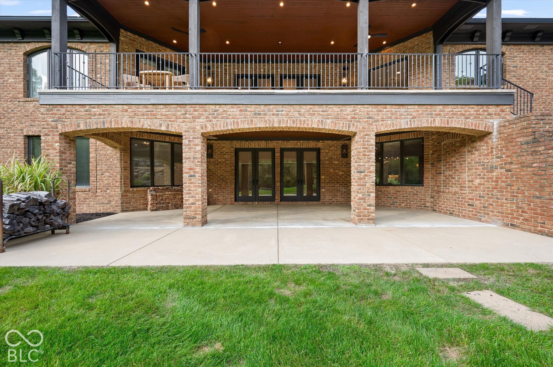 Covered patio with brick arches and concrete flooring