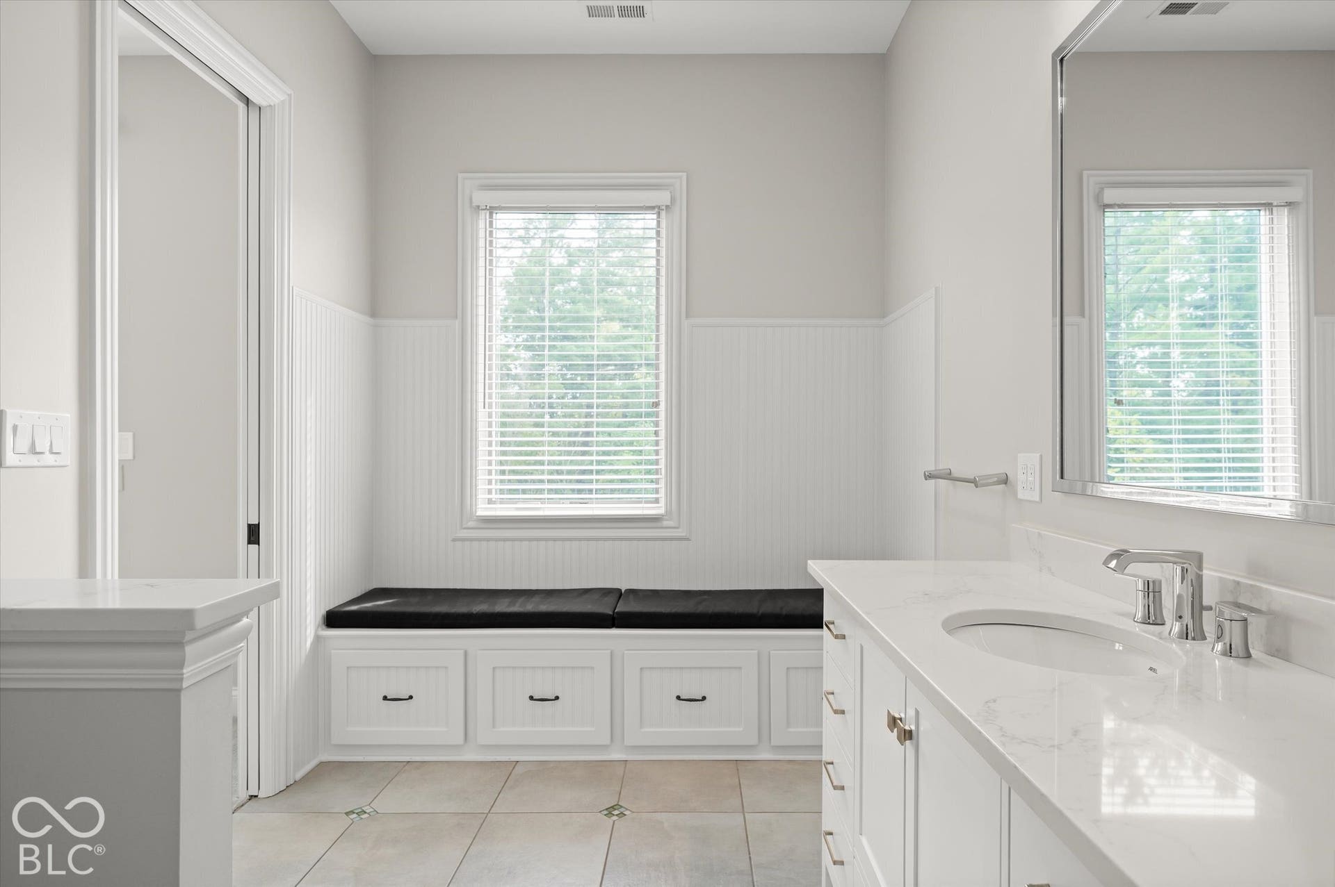 White vanity with integrated sink and chrome fixtures