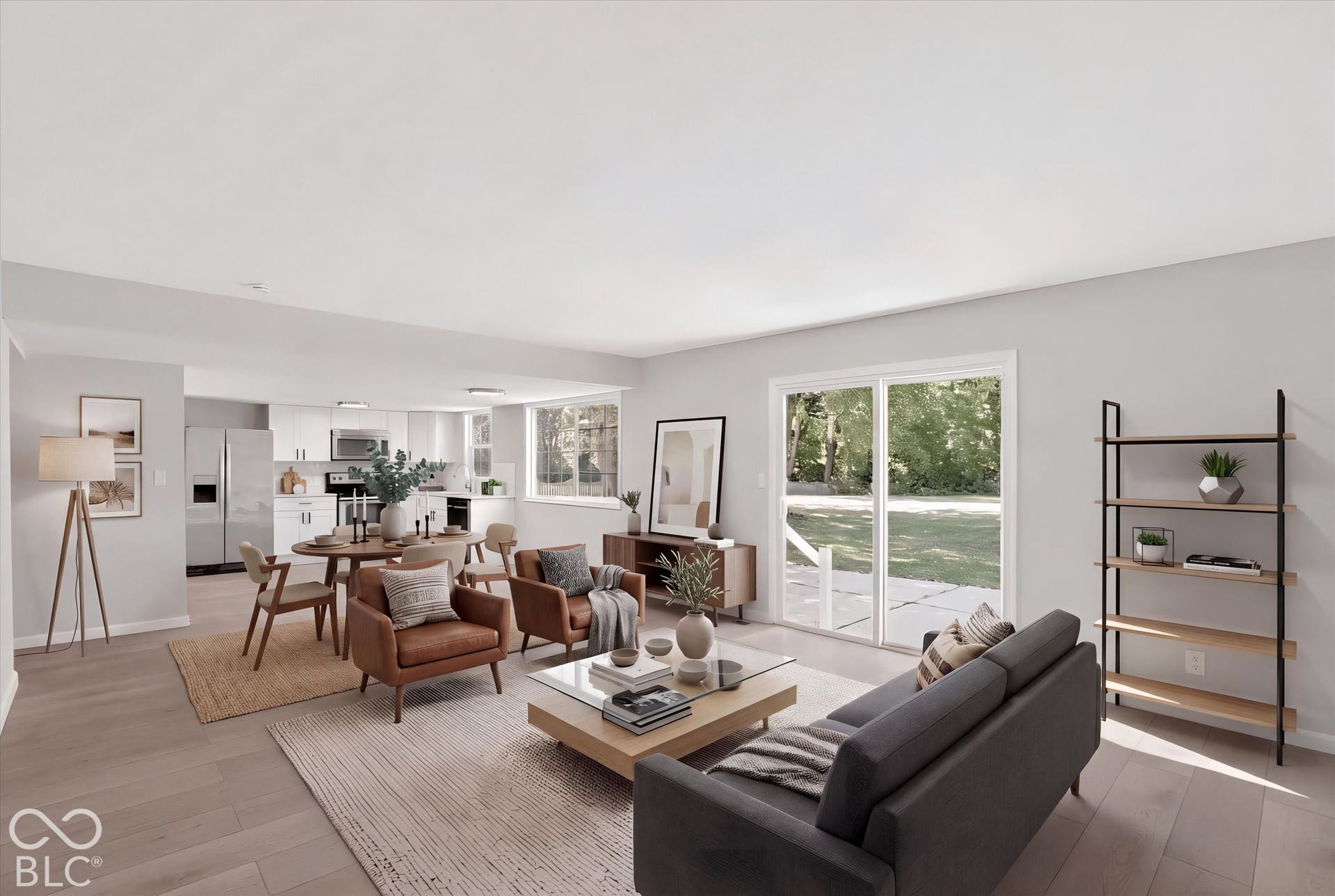 Virtually Altered - Light wood-finish flooring throughout, white painted walls, and white kitchen cabinetry