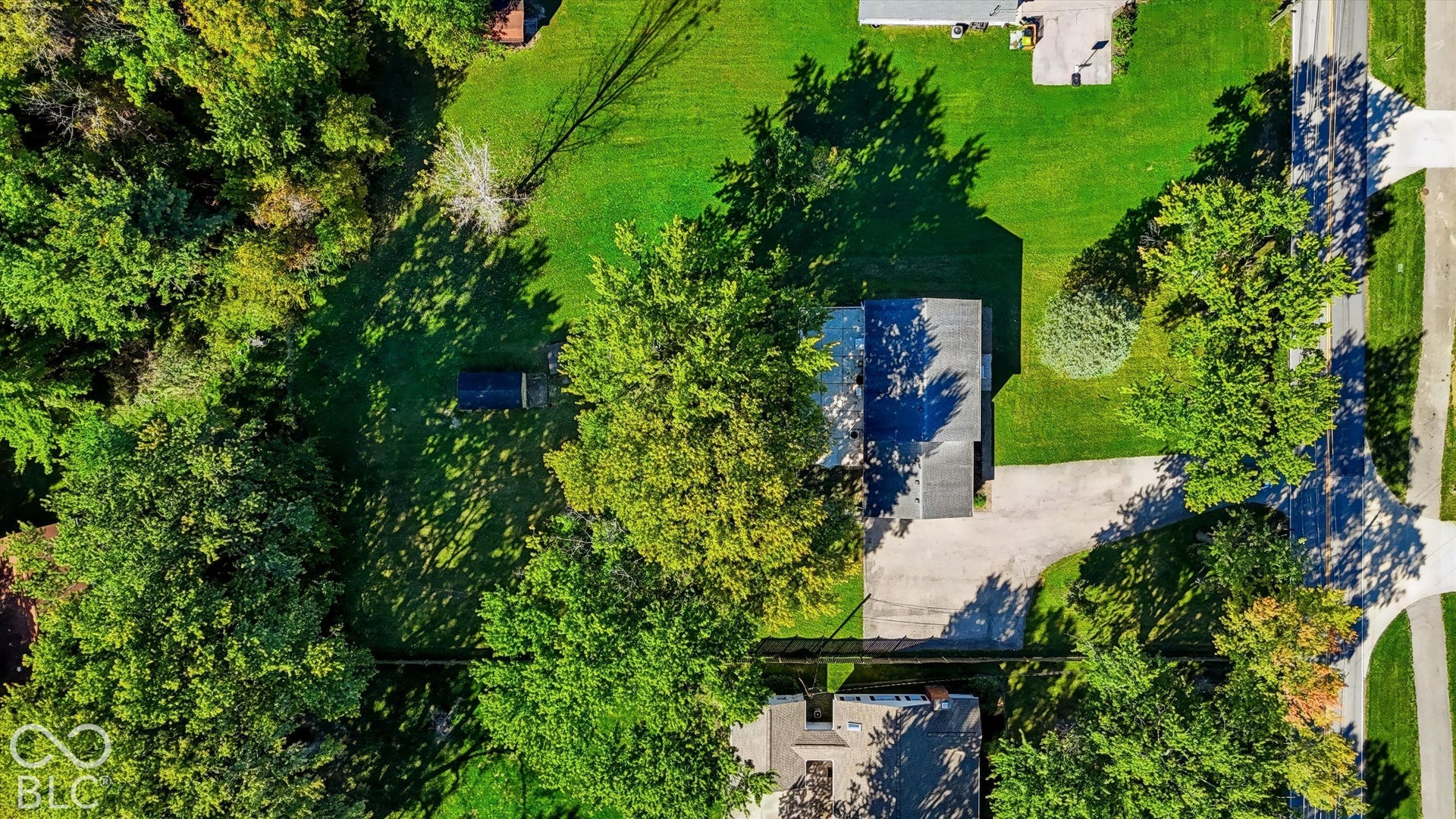 Lush landscaping with mature trees and verdant lawn creates a serene outdoor setting