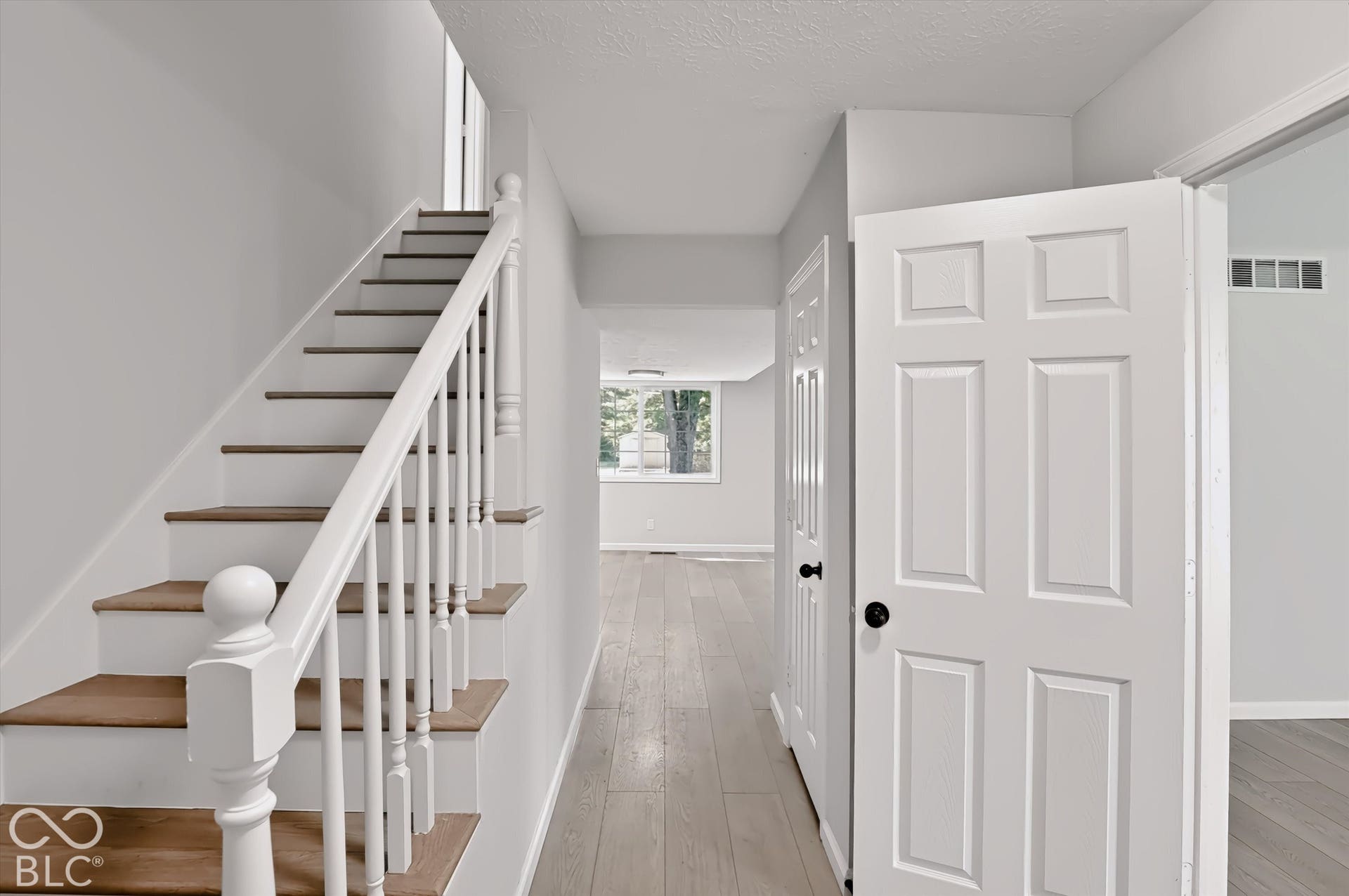 Staircase with wood-finish treads and white balusters