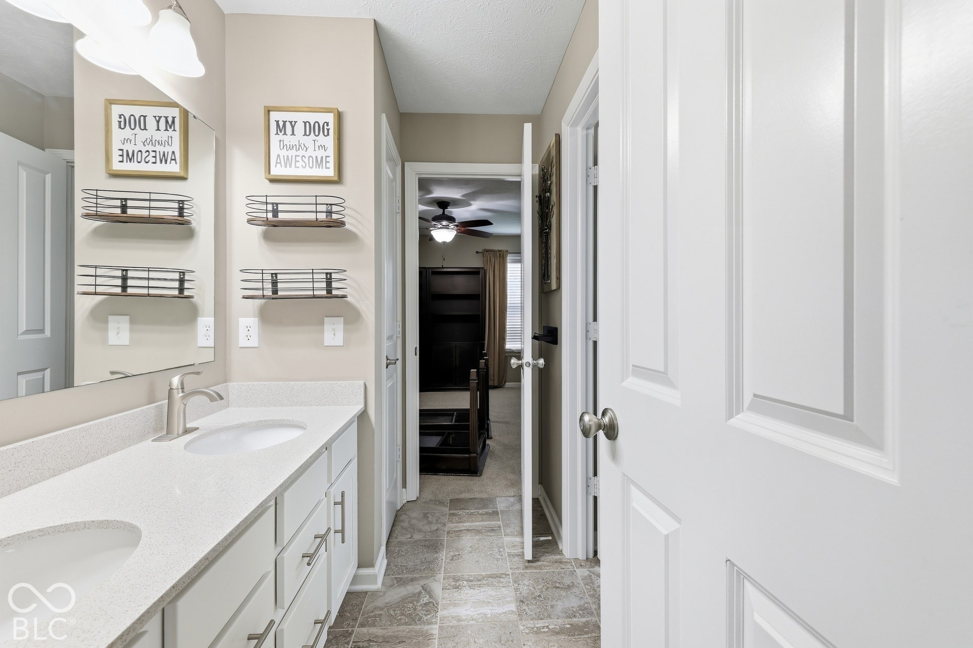 Jack & Jill bath, dual vanity with integrated sinks, brushed nickel fixtures, upgraded toilets throughout, and white cabinetry