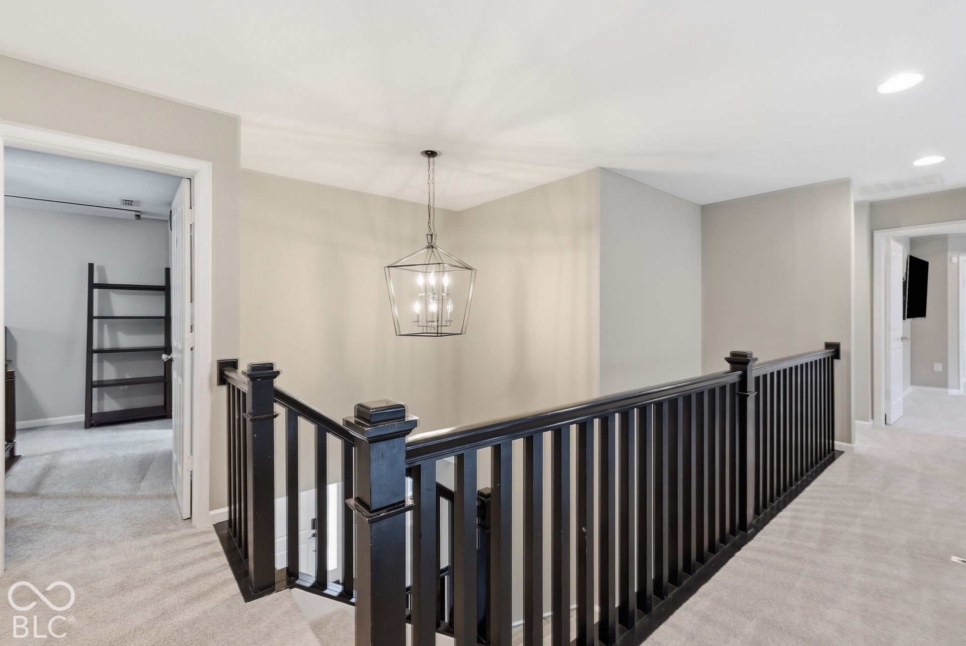 Staircase featuring dark wood banister and spindles