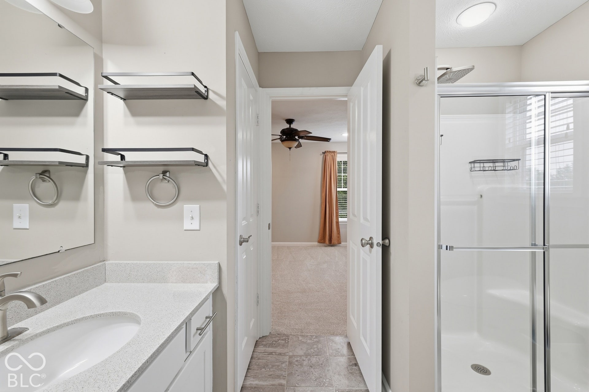 Private bath for bedroom 5, vanity with a light-colored countertop and undermount sink, brushed nickel faucet