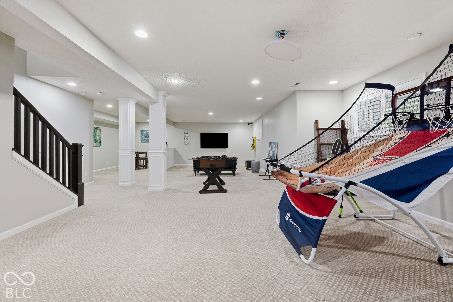 Expansive finished basement with recessed lighting, and daylight windows