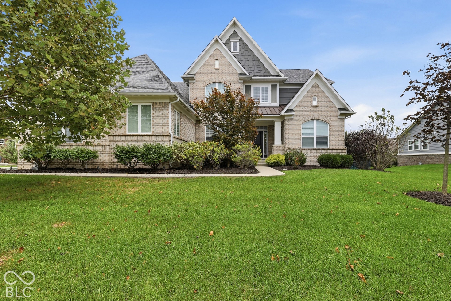 Brick exterior with gabled roof lines and gray siding accents