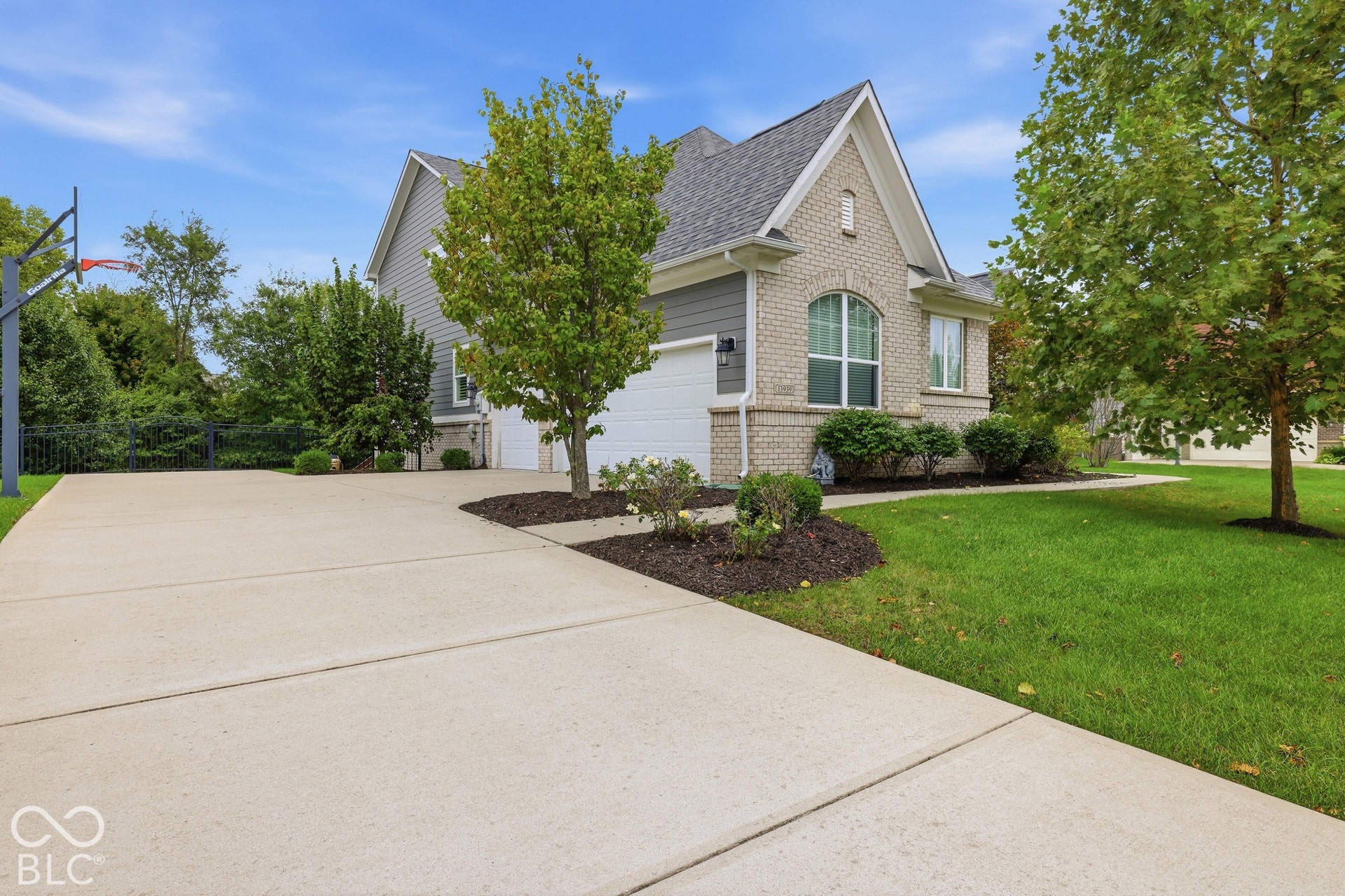 Brick and siding exterior with an arched window