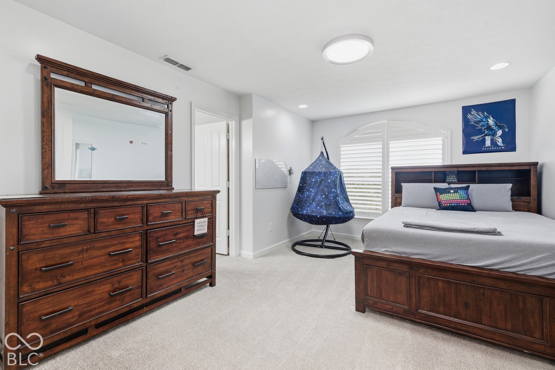 Bedroom 3, arched window with plantation shutters, recessed lighting, ceiling-mounted light fixture, and new light-toned carpet flooring