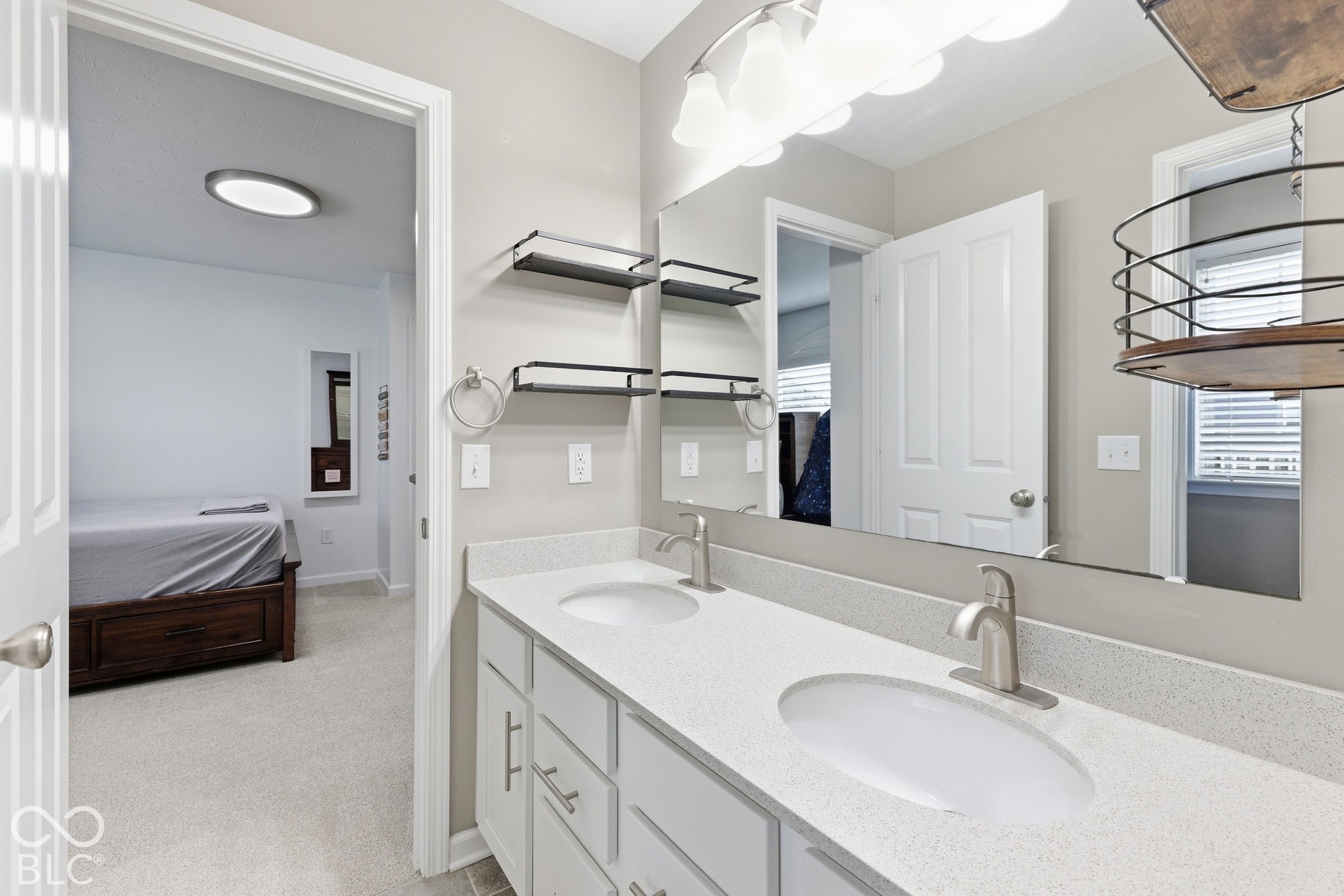 Jack & Jill bath, double vanity with dual undermount sinks, stone-finish countertop, and brushed nickel fixtures