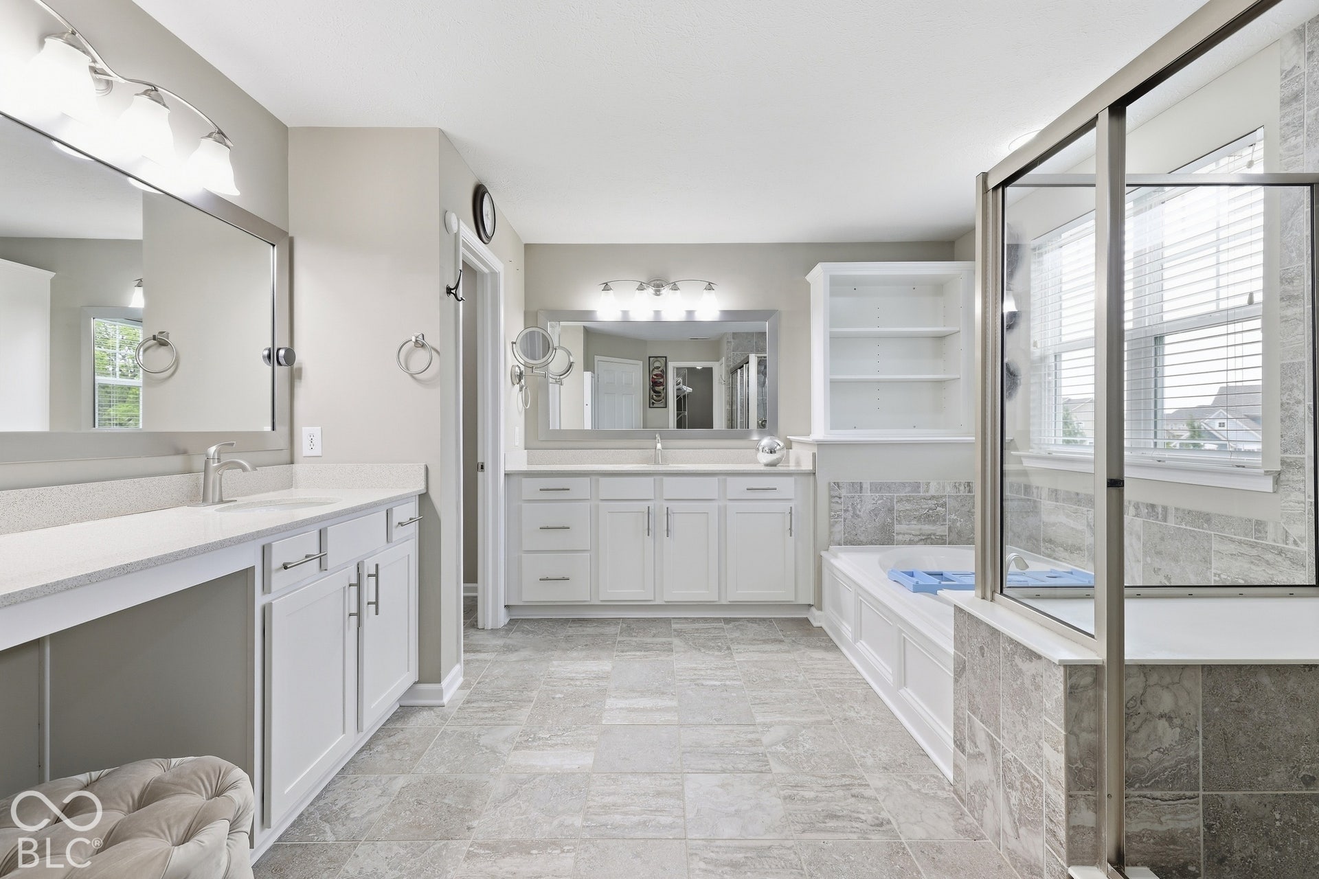 Dual white vanity with undermount sinks, stone-look countertops, and chrome fixtures