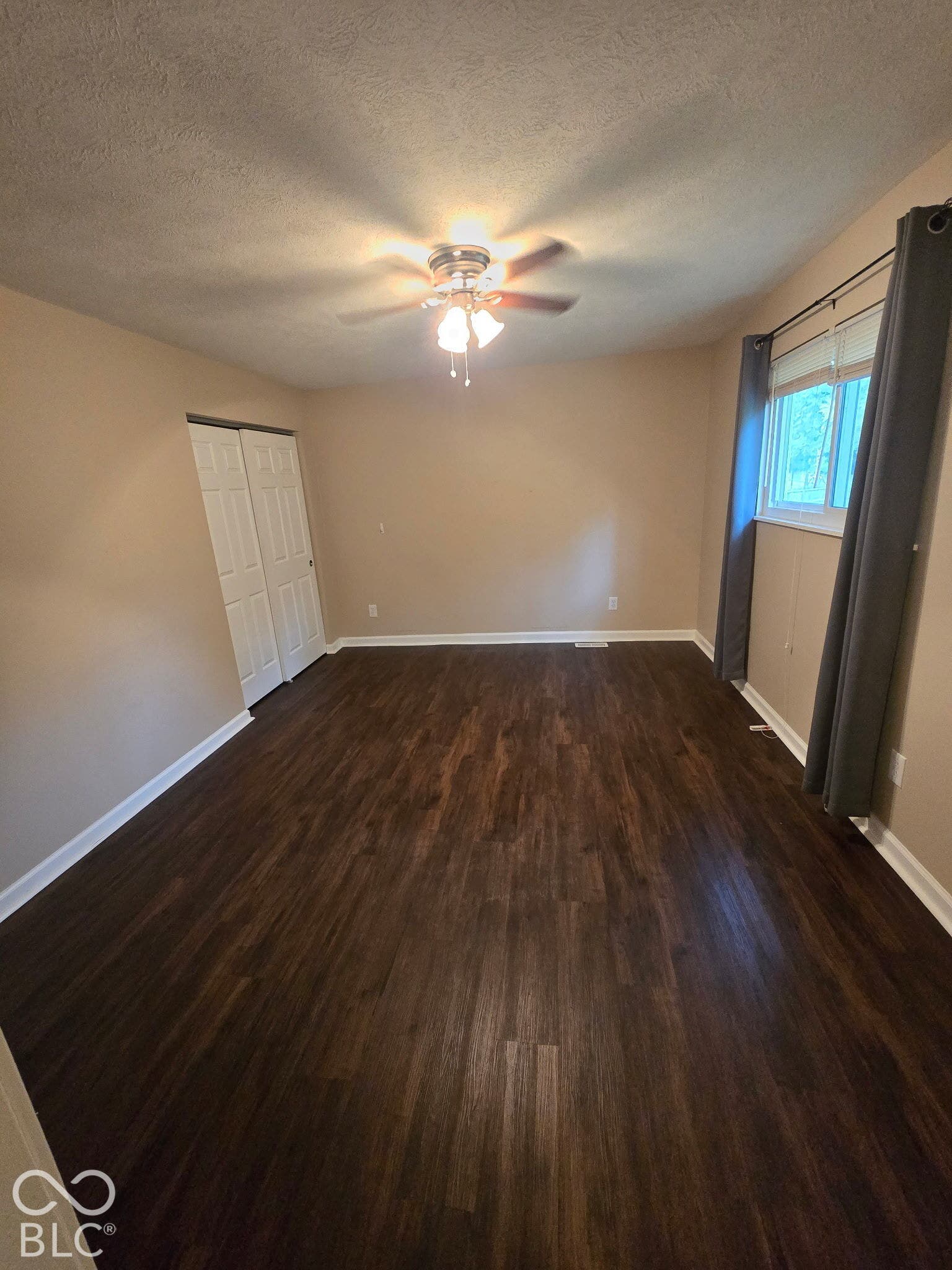 Dark wood-finish flooring with white trim