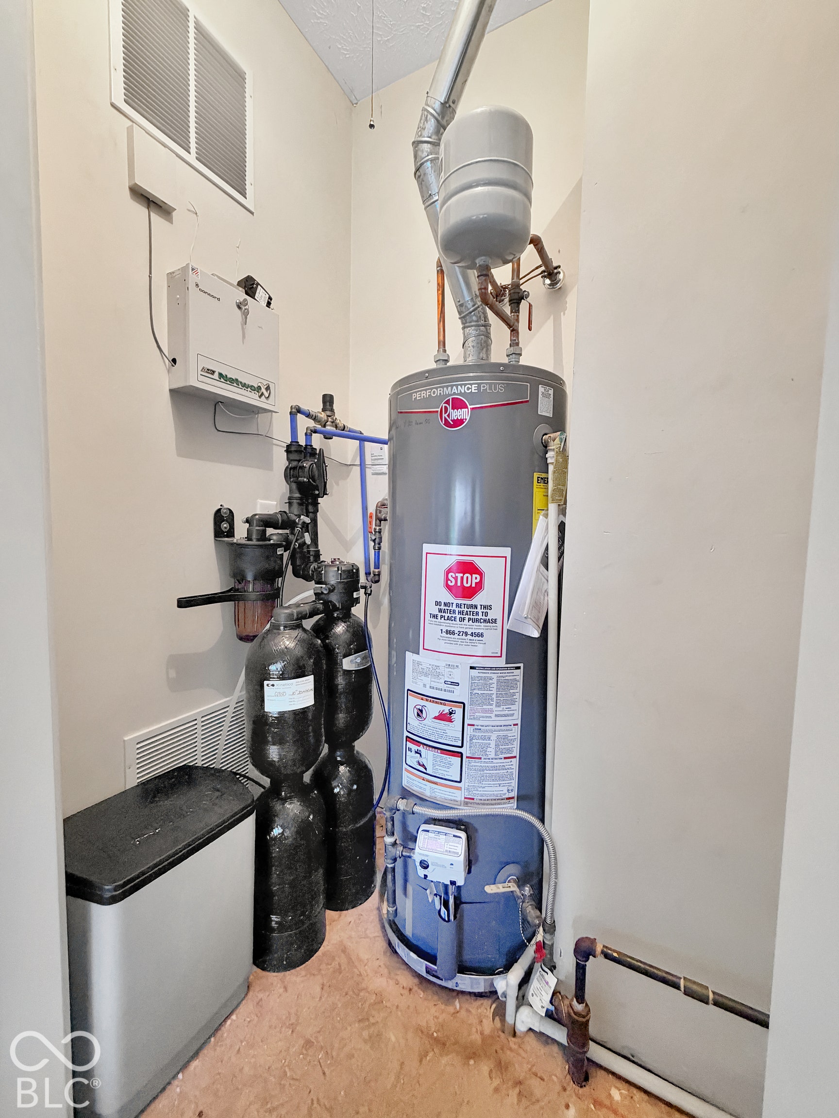 Mechanical room featuring water heater installed at 2022 and Kenetico water filtration system.