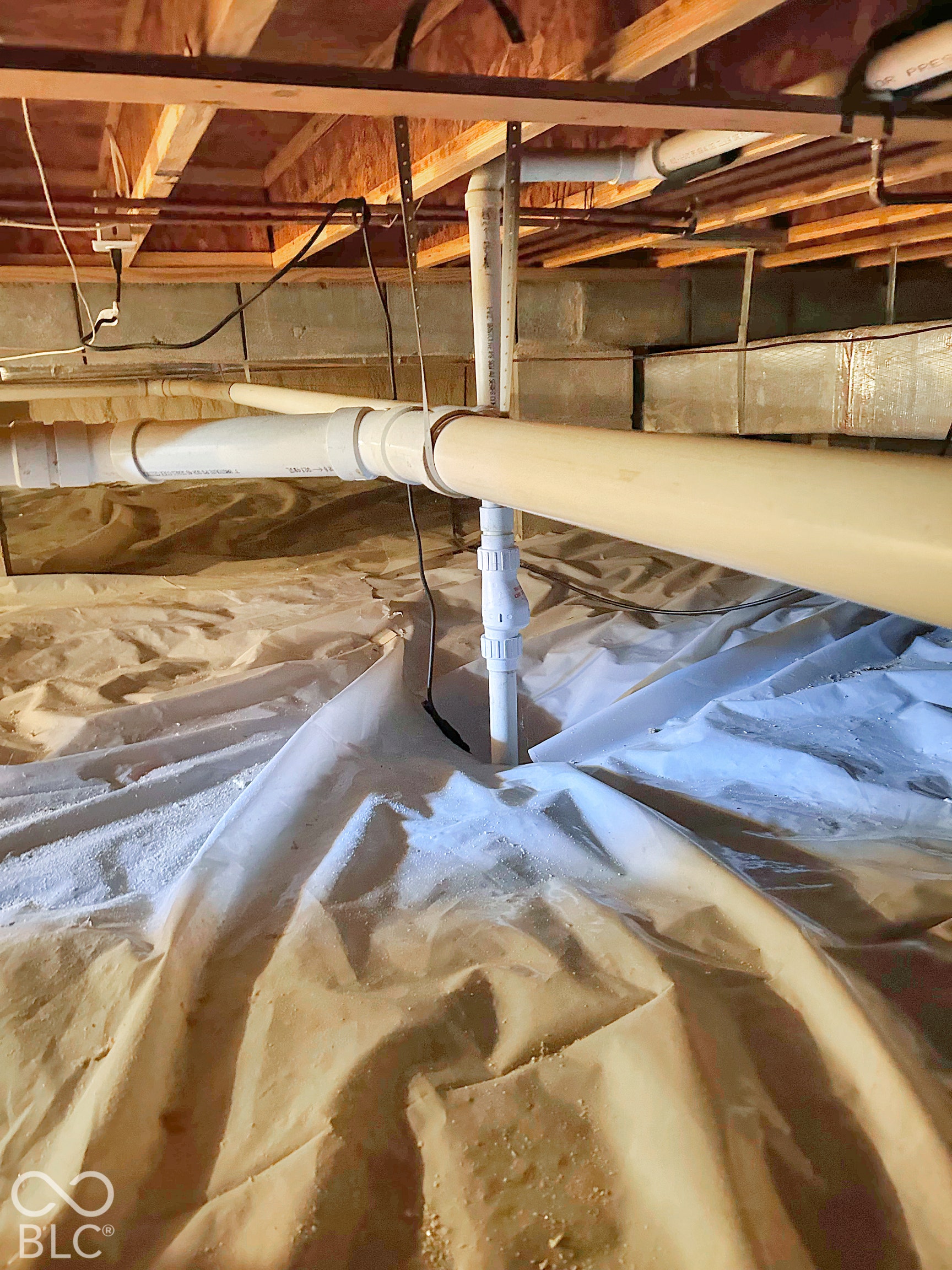 Encapsulated and spray foam insulated crawlspace with sump pump.
