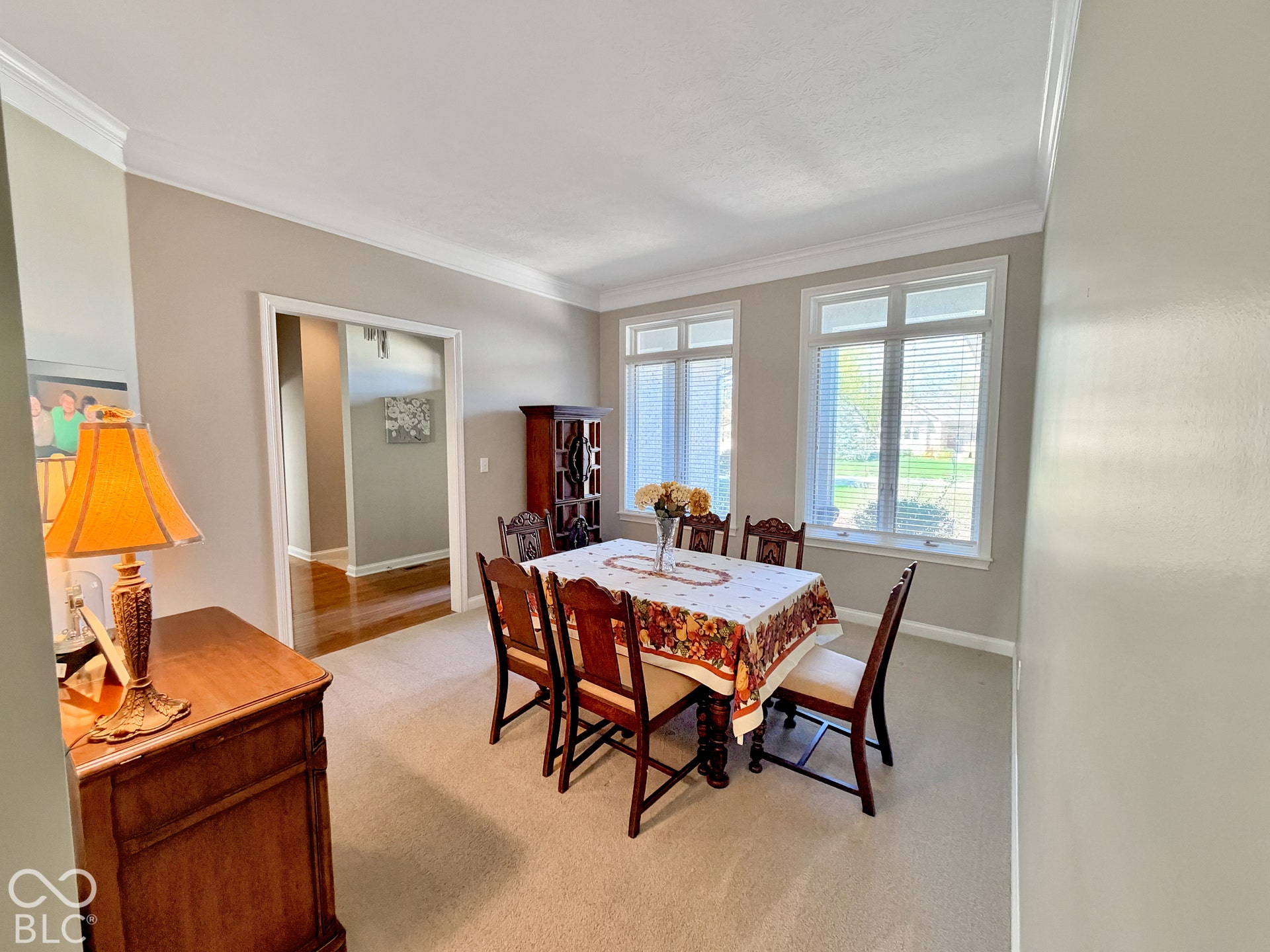 Dining room featuring multiple windows, and crown molding