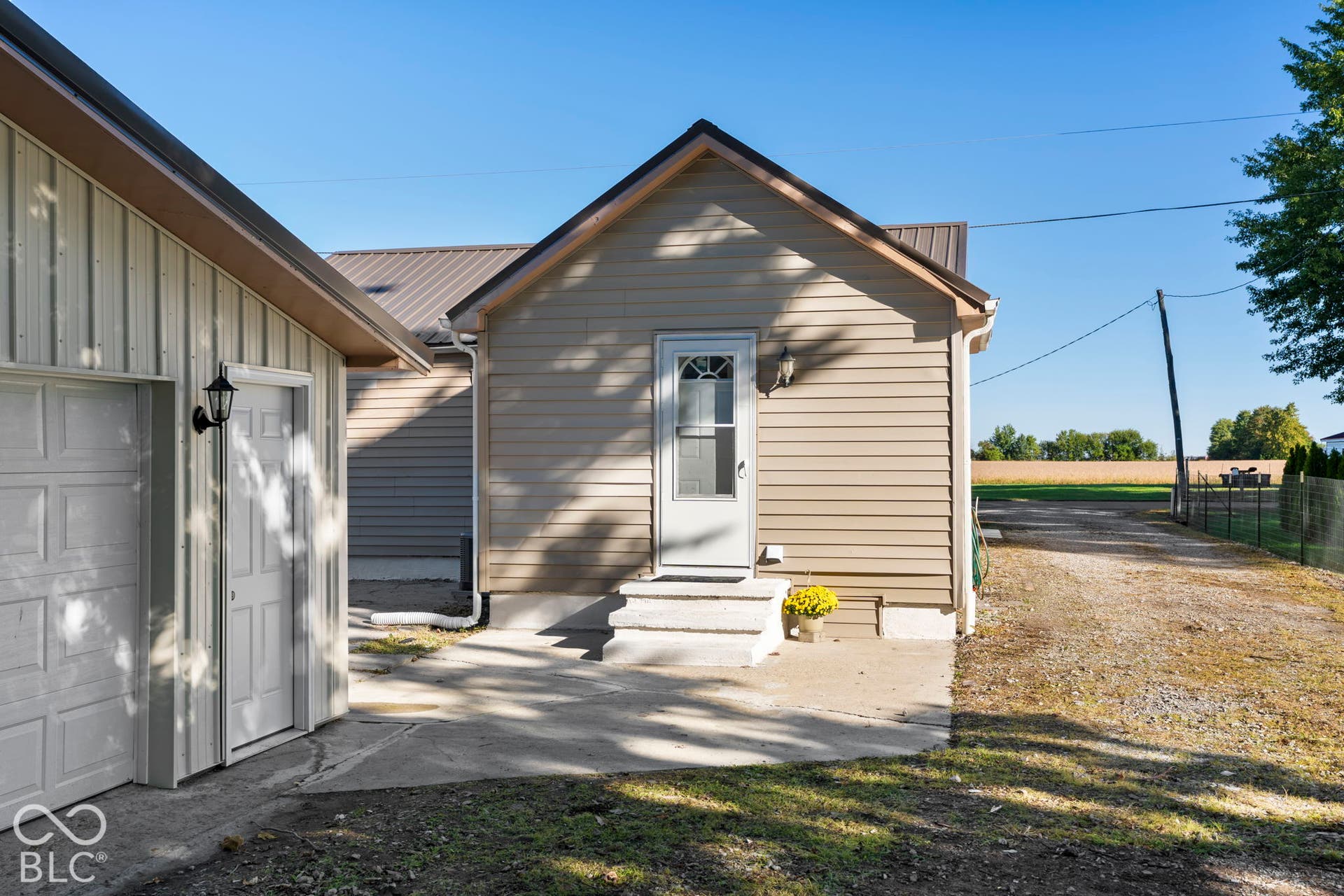 Exterior entry with a paneled door, two steps, and concrete landing
