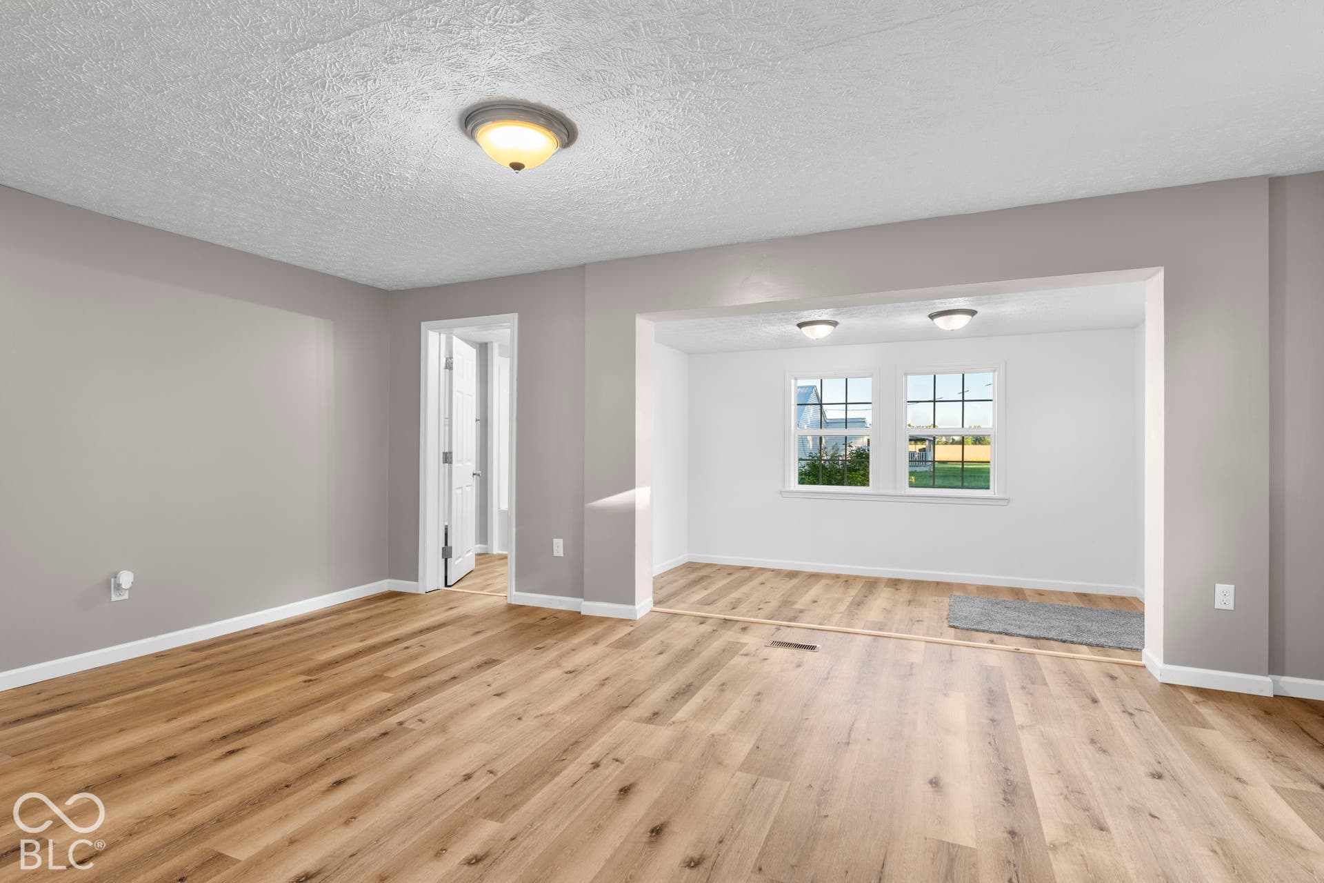 Wood-finish flooring throughout, light gray wall paint, and white trim