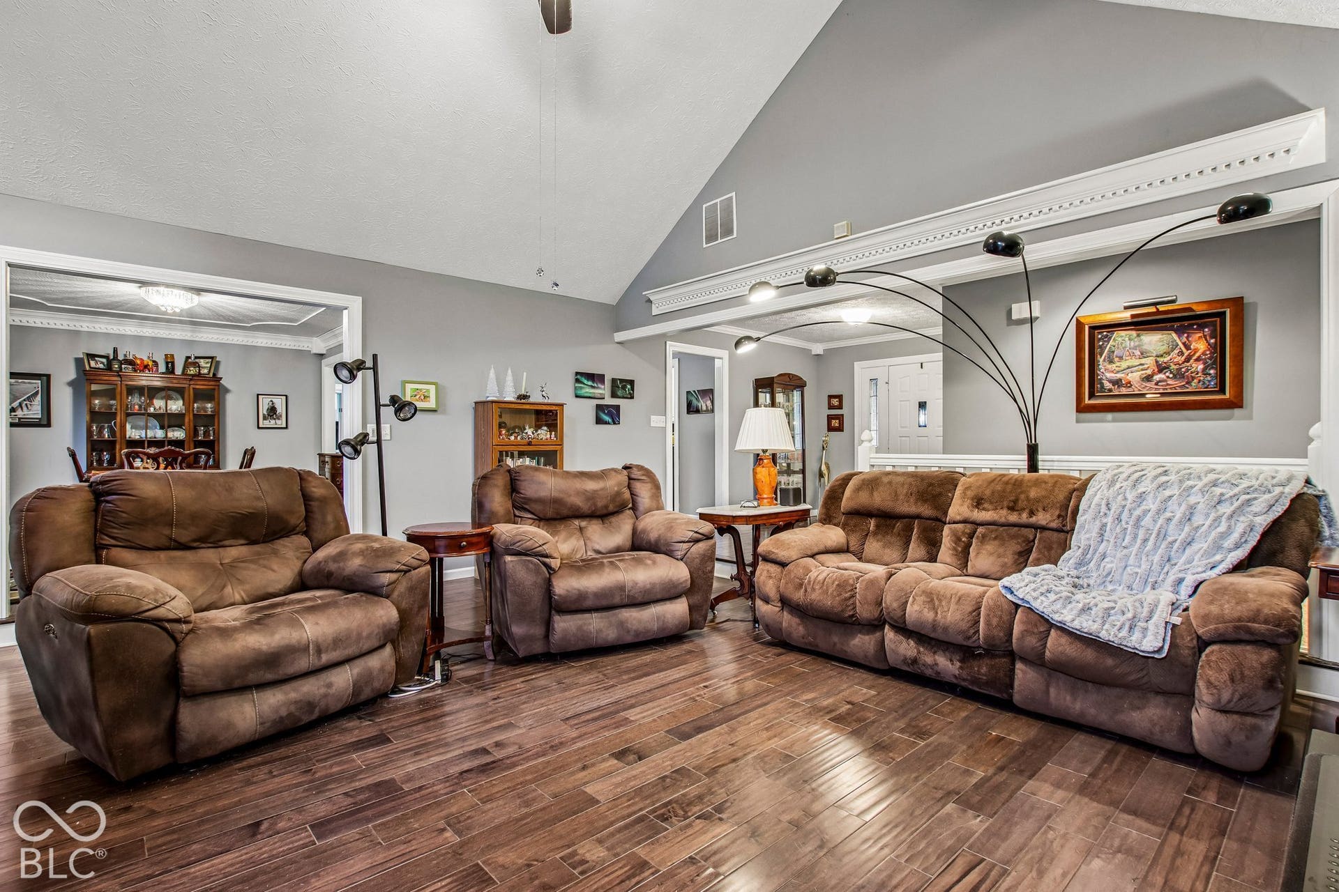 View of living room with 16' ceiling and updated laminate hardwood flooring
