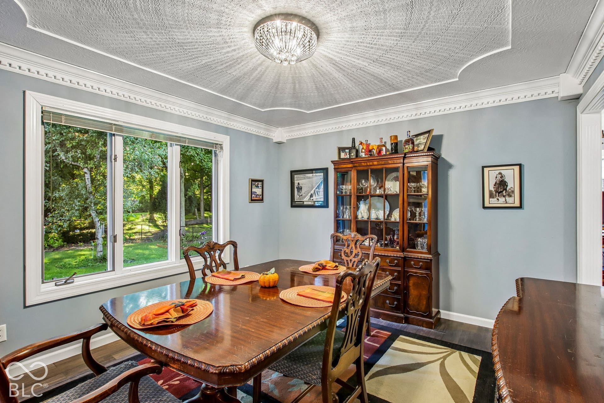 View of dining room with decorative inset ceiling, bay window and updated laminate hardwood flooring