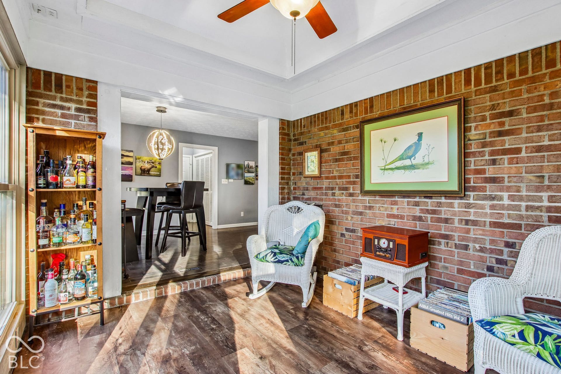 View of updated fully enclosed, heated and cooled sunroom with ceiling fan
