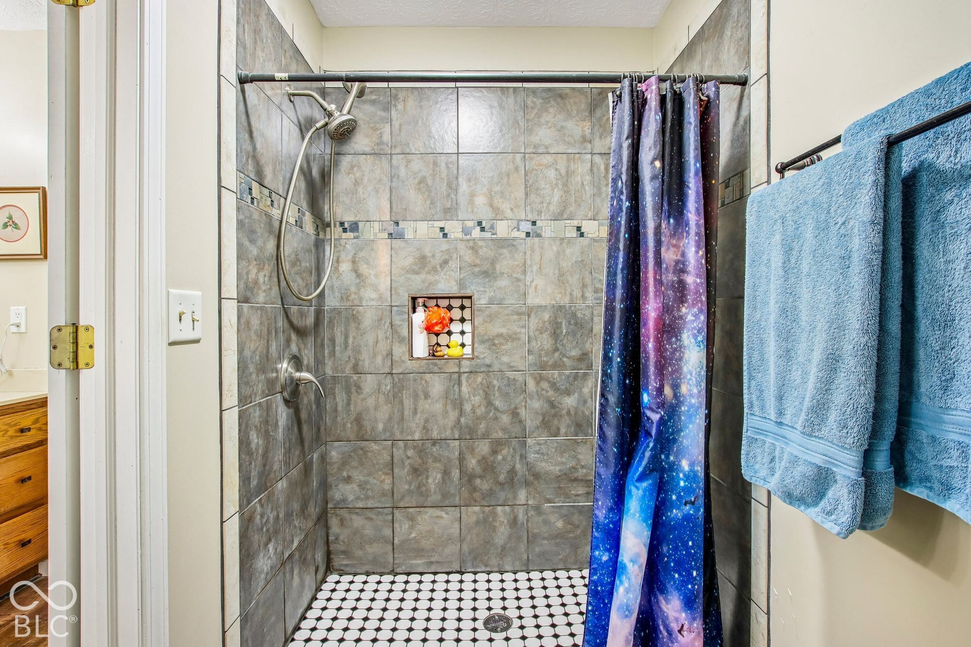 View of updated tile shower in primary bathroom