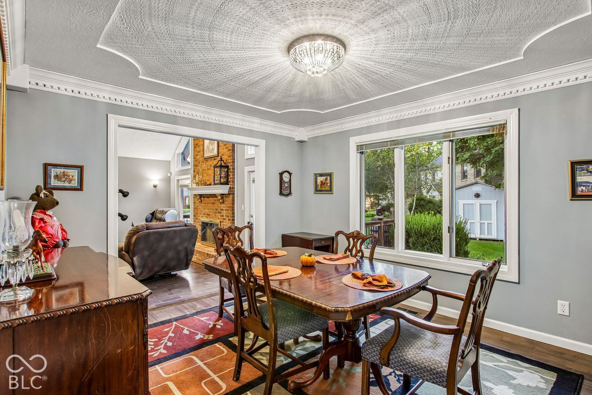 View of dining room with decorative inset ceiling, bay window and updated laminate hardwood flooring