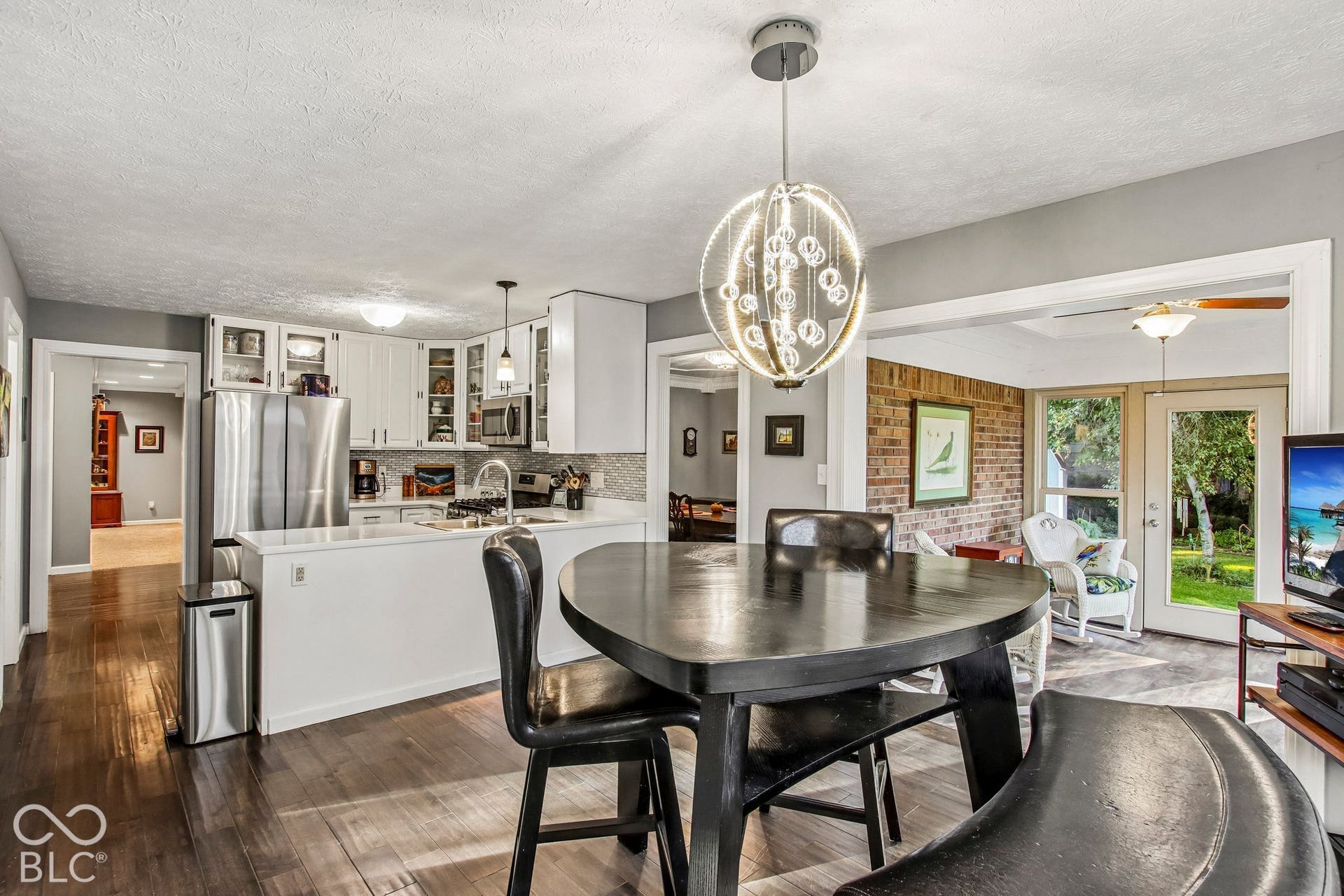 View of dining area, kitchen and sunroom