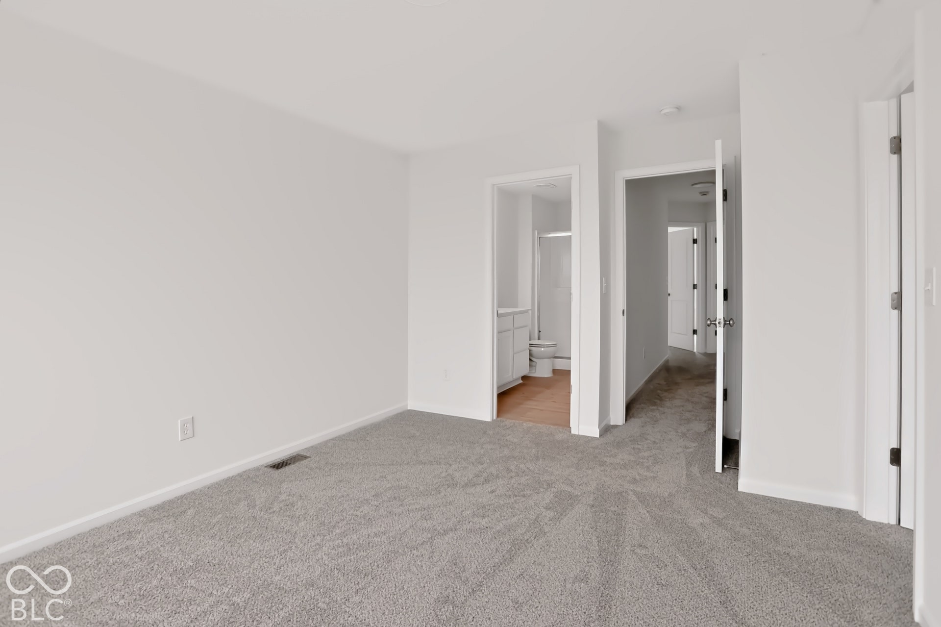 Plush gray carpeting throughout, featuring white walls and white trim