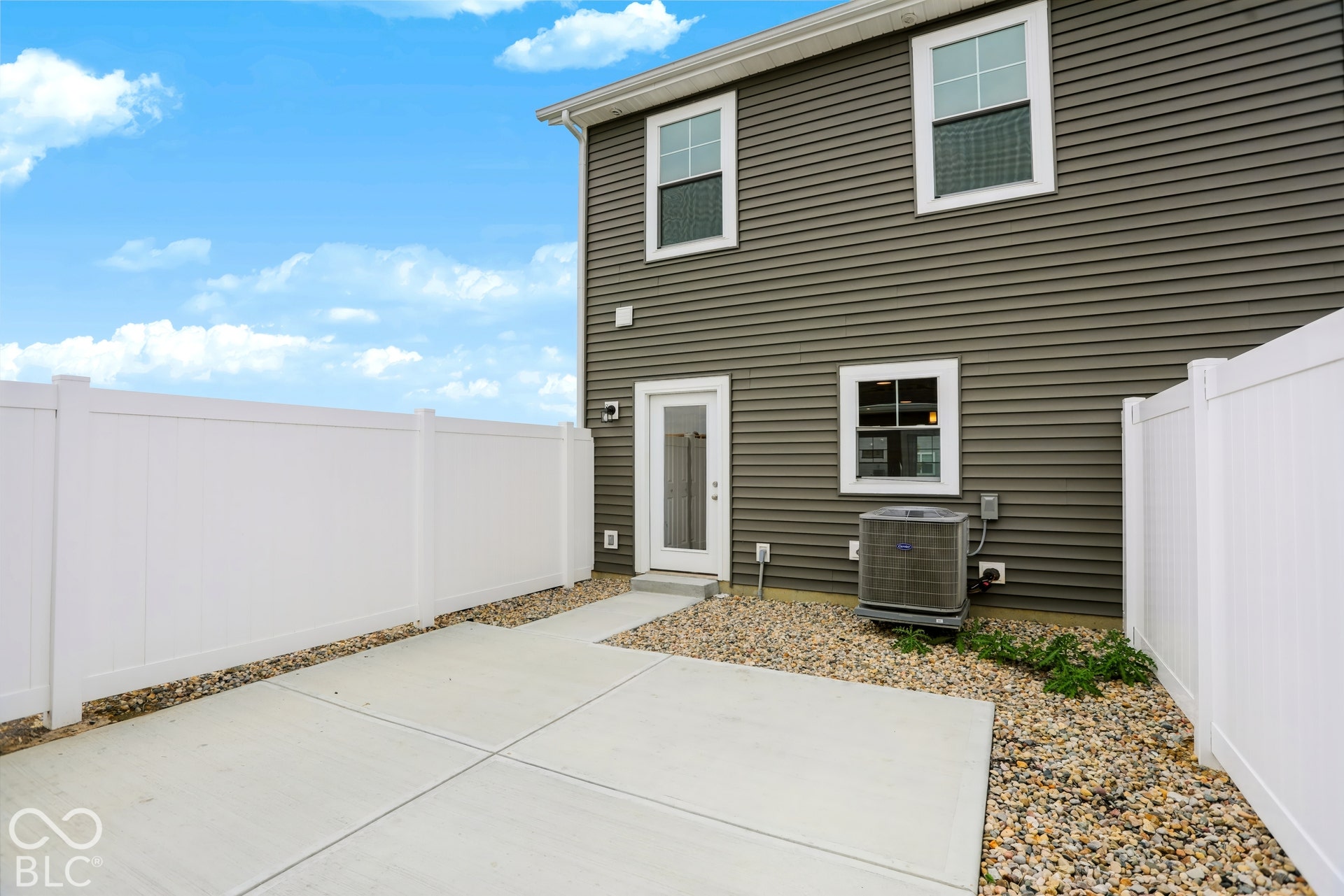 Private patio with concrete paving and gravel accents