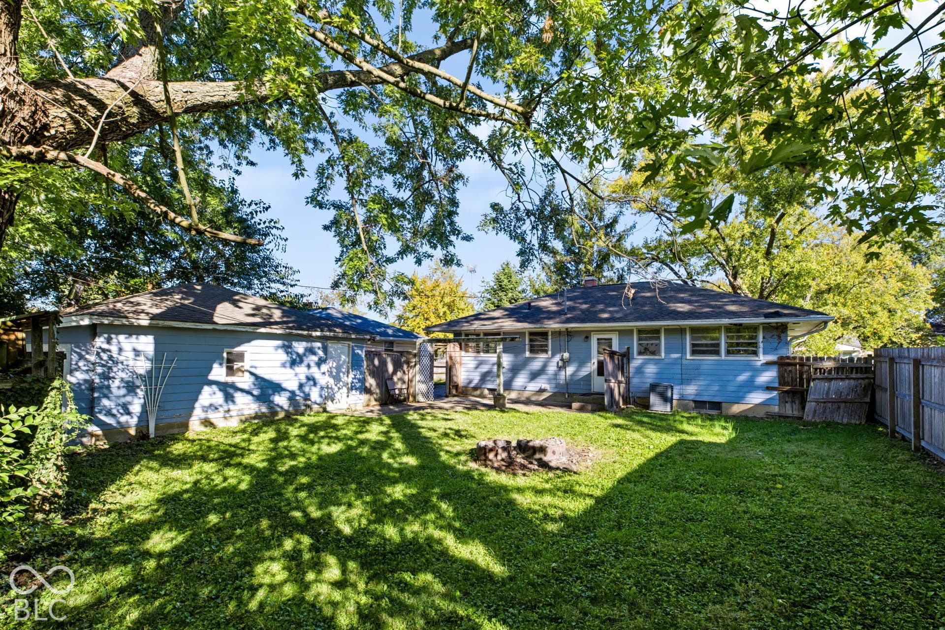 Expansive yard featuring a manicured lawn and mature trees