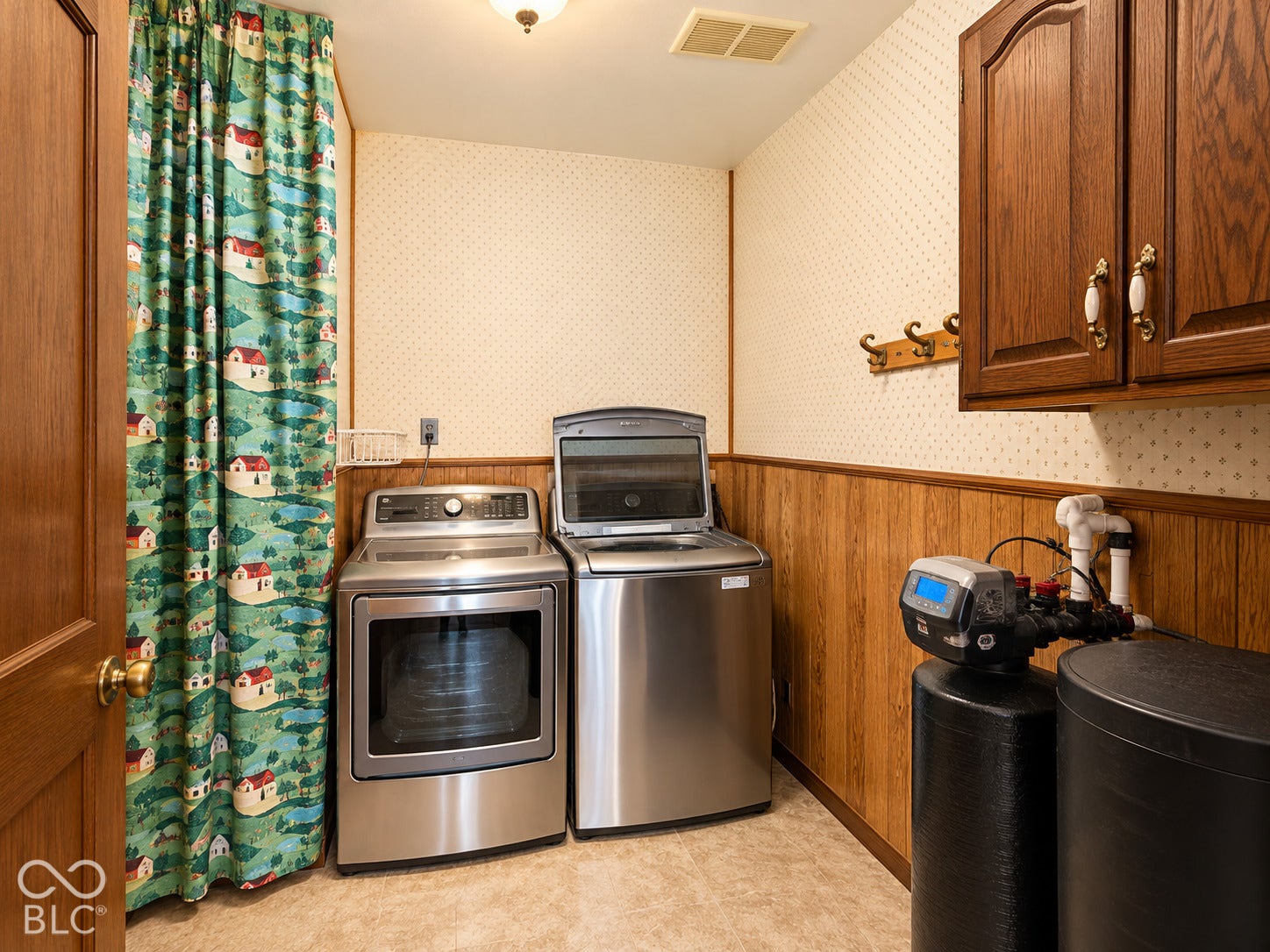 3680 S State Road 75, Coatesville, IN 46121 Laundry area with wood-finish wainscoting, upper cabinetry, and a water treatment system