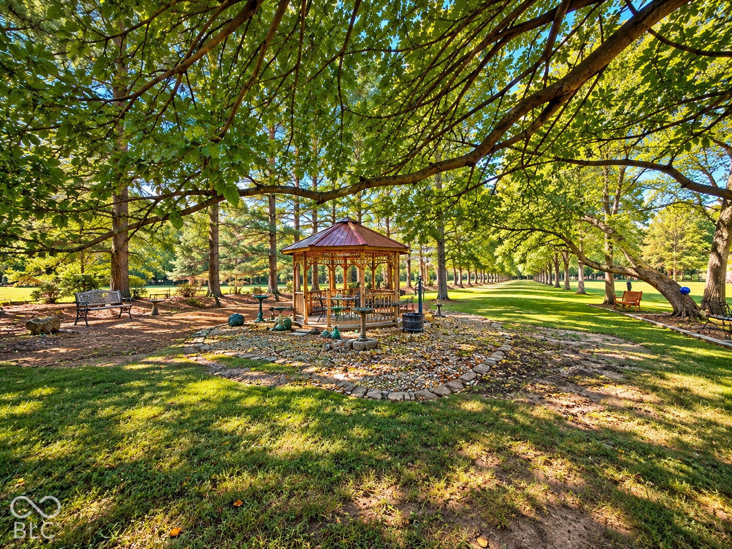 3680 S State Road 75, Coatesville, IN 46121 Expansive grounds featuring a wood gazebo with a metal roof, mature trees, and a tree-lined driveway
