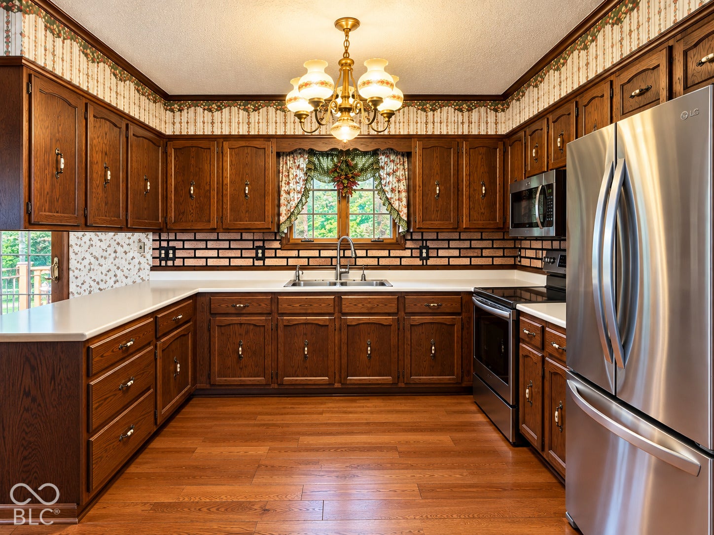 3680 S State Road 75, Coatesville, IN 46121 Wood-finish flooring, ample wood cabinetry, white countertops, brick-style backsplash, and stainless steel appliances