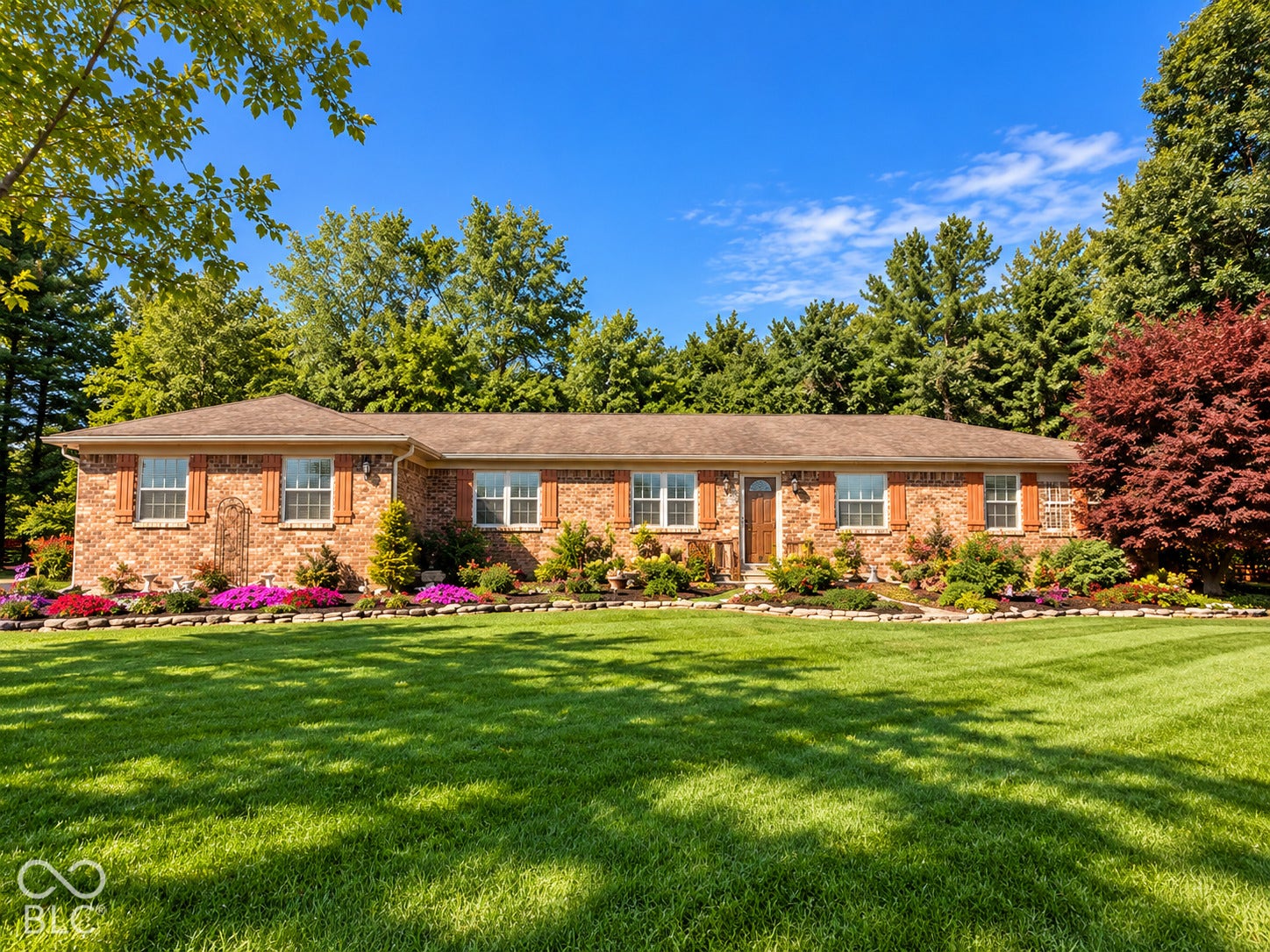 3680 S State Road 75, Coatesville, IN 46121 Brick exterior with decorative window shutters and a wood-finish entry door