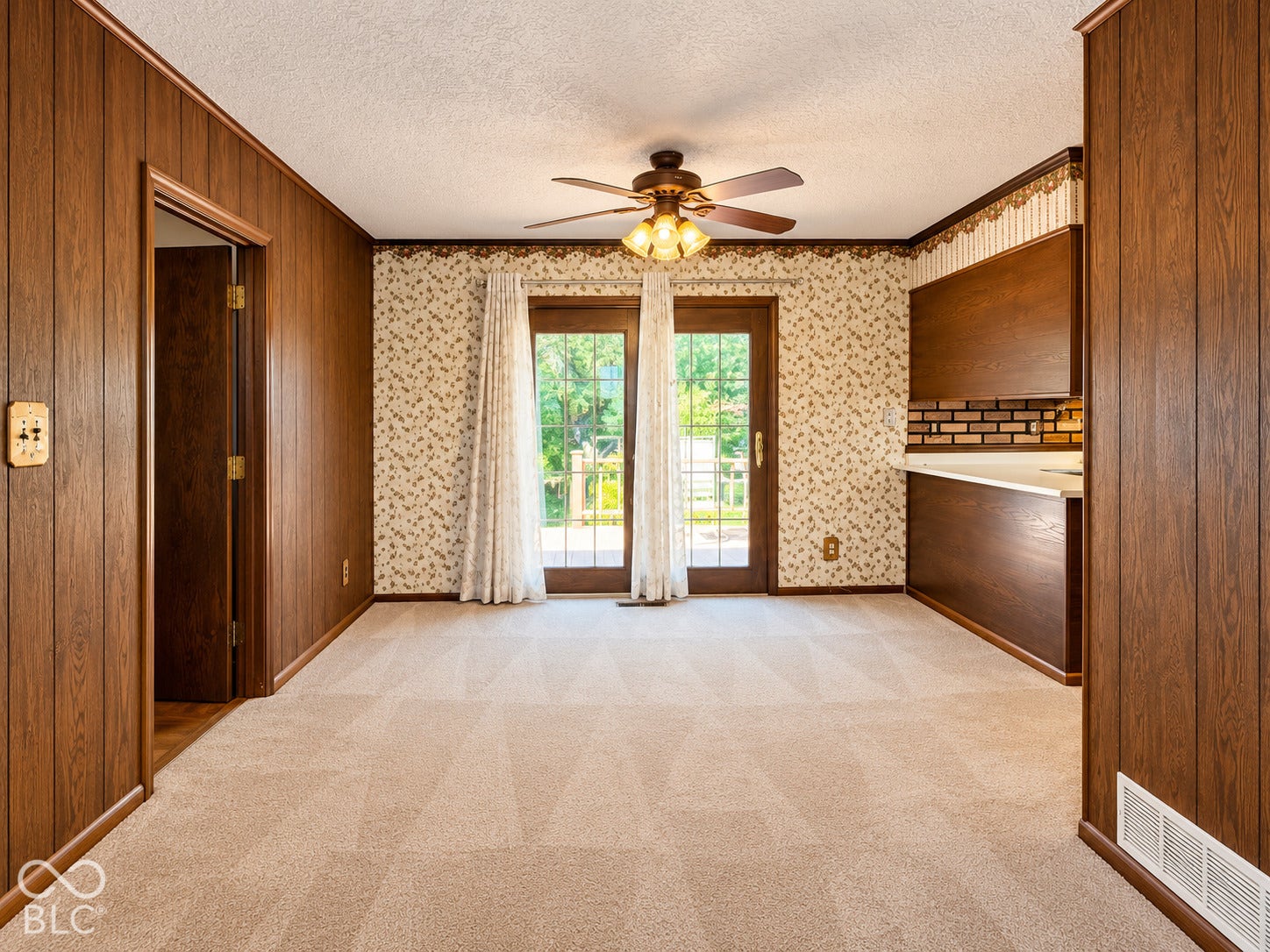 3680 S State Road 75, Coatesville, IN 46121 Wood paneling throughout, built-in cabinetry, dual glass panel doors, ceiling fan with light fixture, and carpeted flooring
