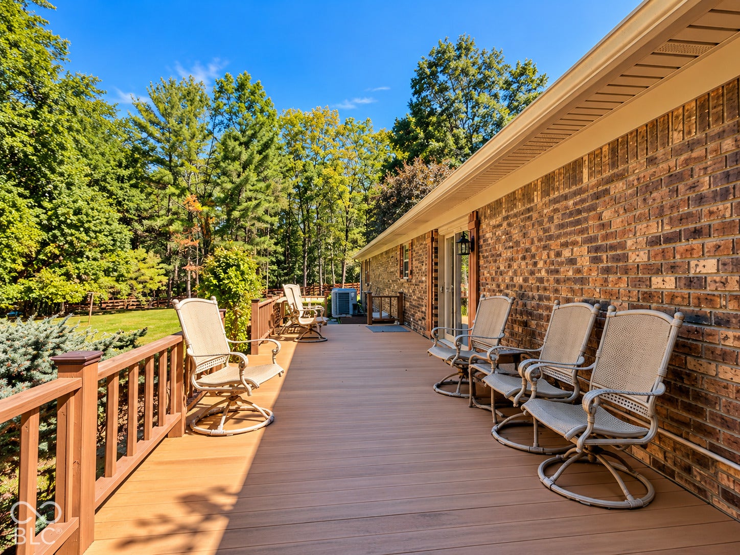 3680 S State Road 75, Coatesville, IN 46121 Expansive composite deck featuring a wooden railing and a brick-faced exterior