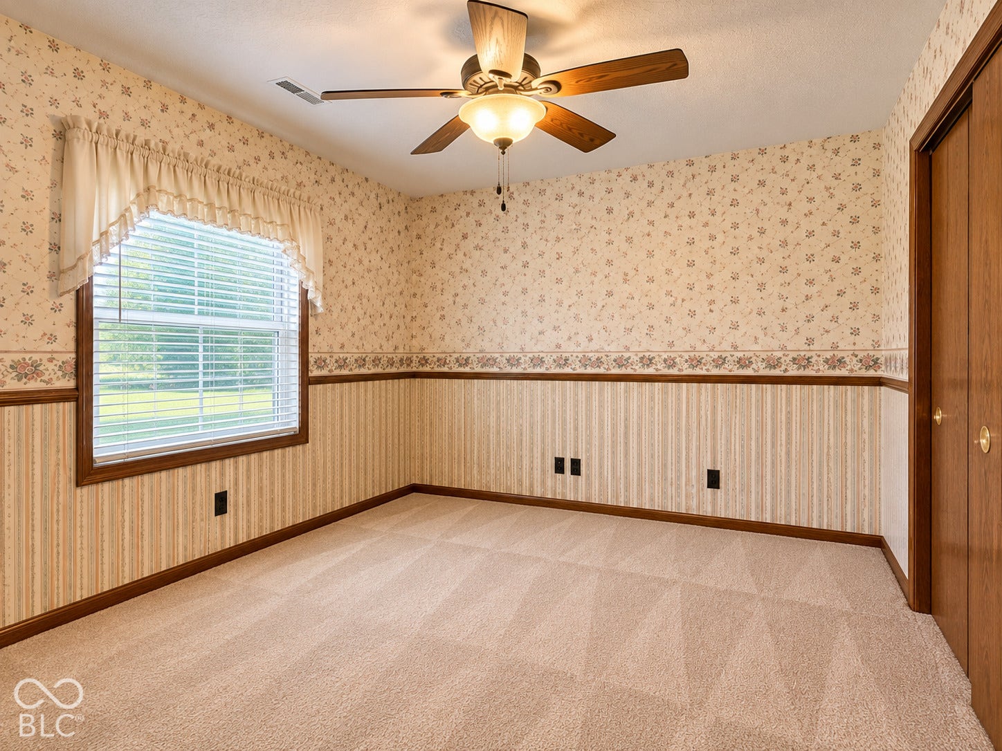 3680 S State Road 75, Coatesville, IN 46121 Wall-to-wall carpeting, wood-finish trim, a window with horizontal blinds, a ceiling fan with integrated lighting, and a built-in closet with wood-finish doors