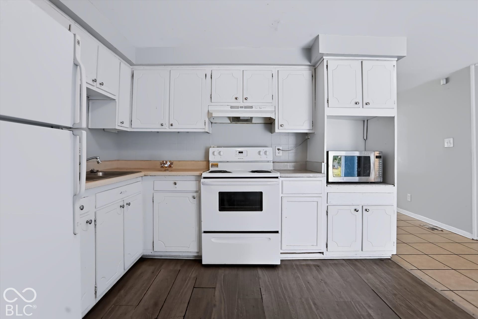 White cabinetry with decorative paneling