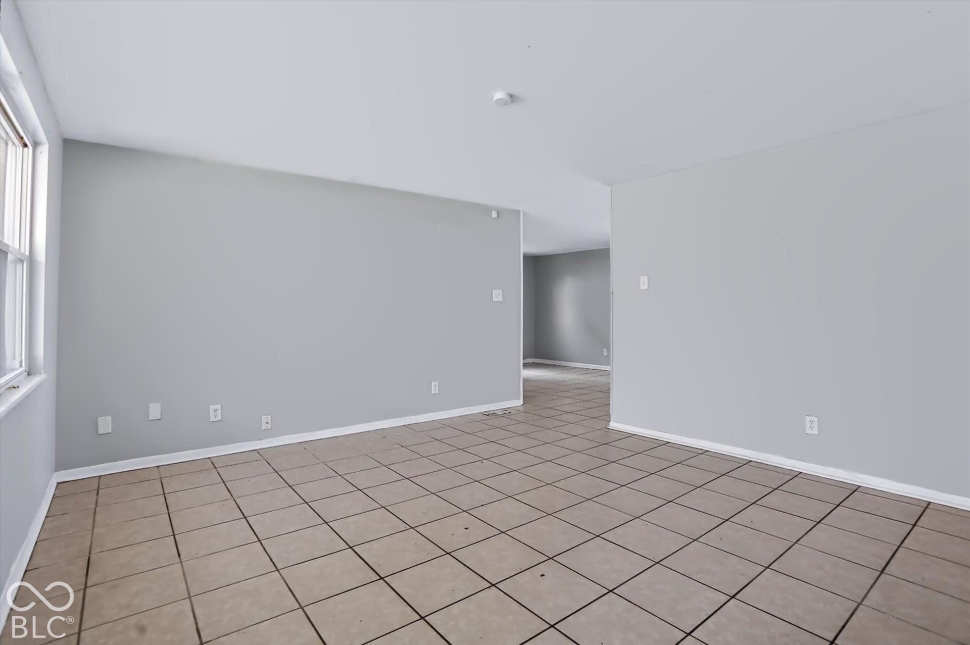 Neutral tone wall paint, tile flooring, and white trim