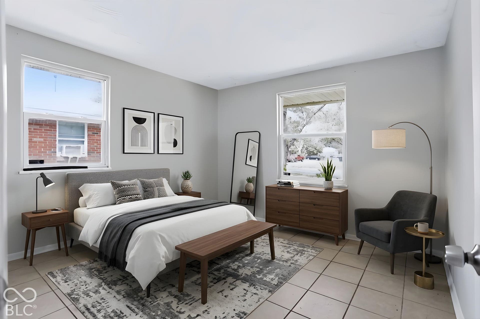 Light-toned tile flooring, light gray wall finishes, and white window trim