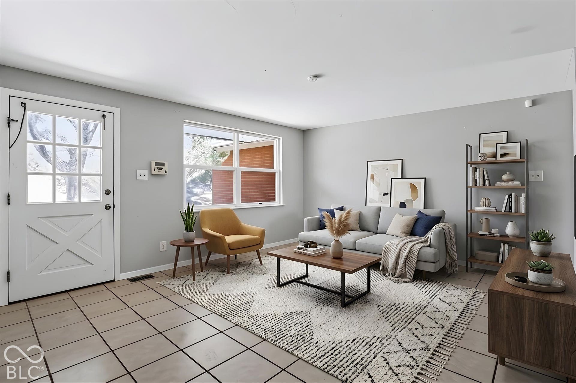 Spacious living area featuring tile flooring and light grey walls