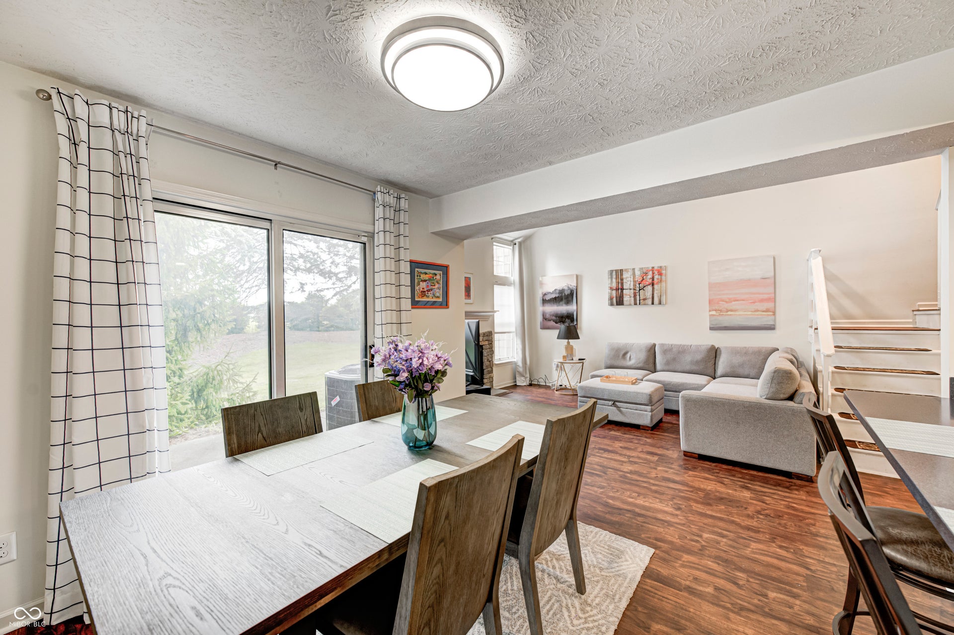 dining area featuring dark wood-type flooring and a textured ceiling