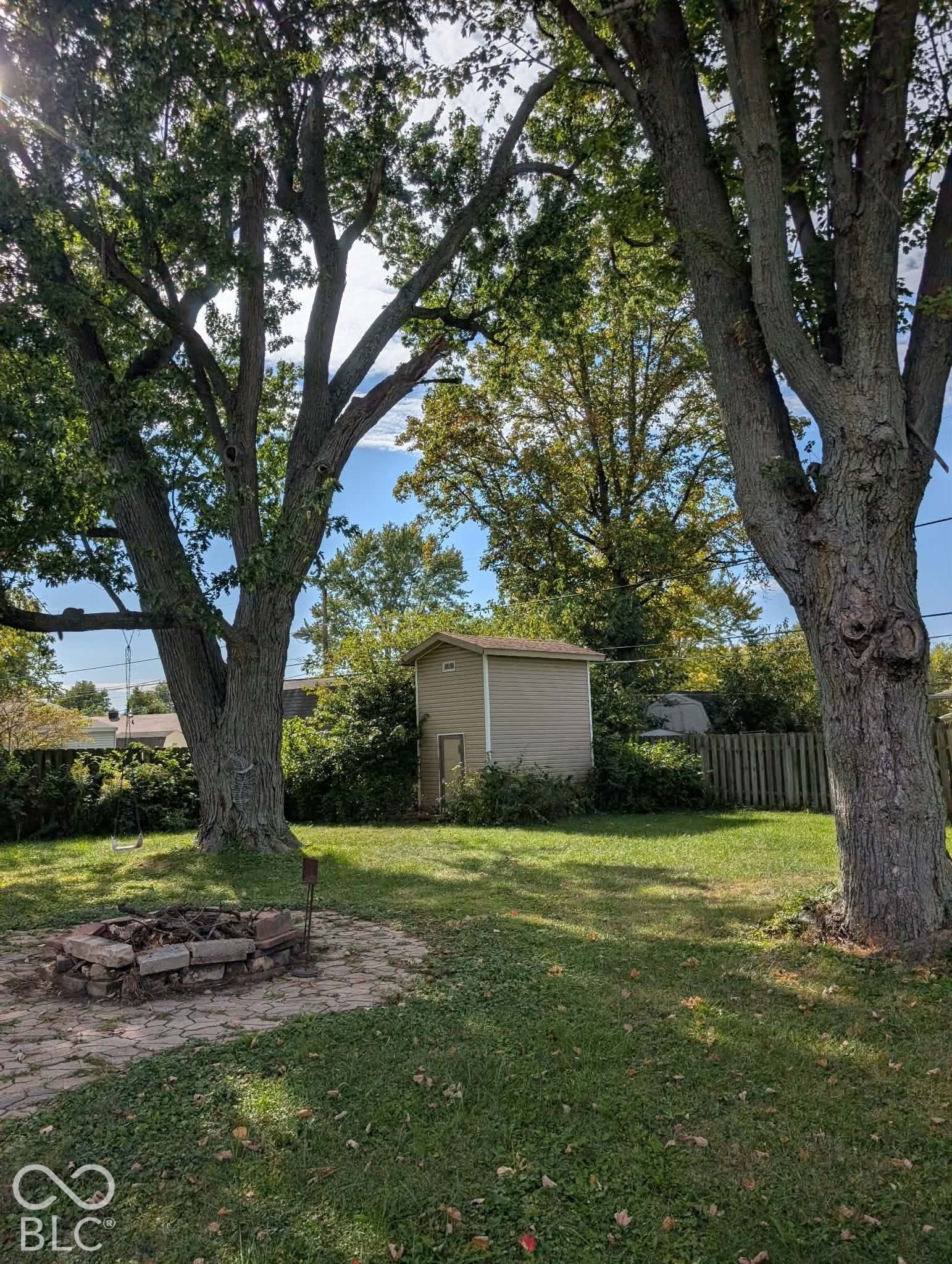 Backyard has a 2 story shed and lots of climbing trees!
