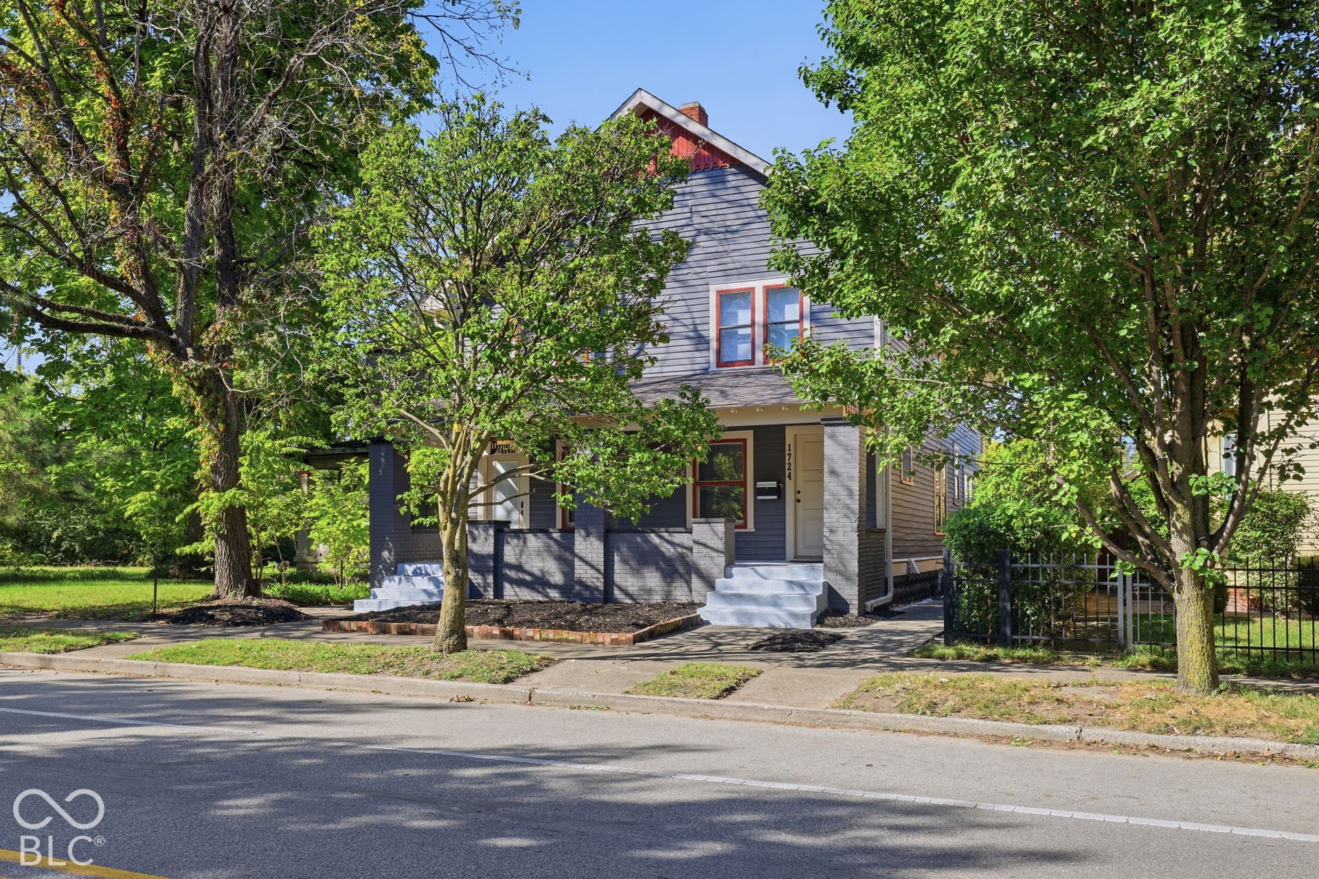 Two-story exterior with gray siding and red trim accents