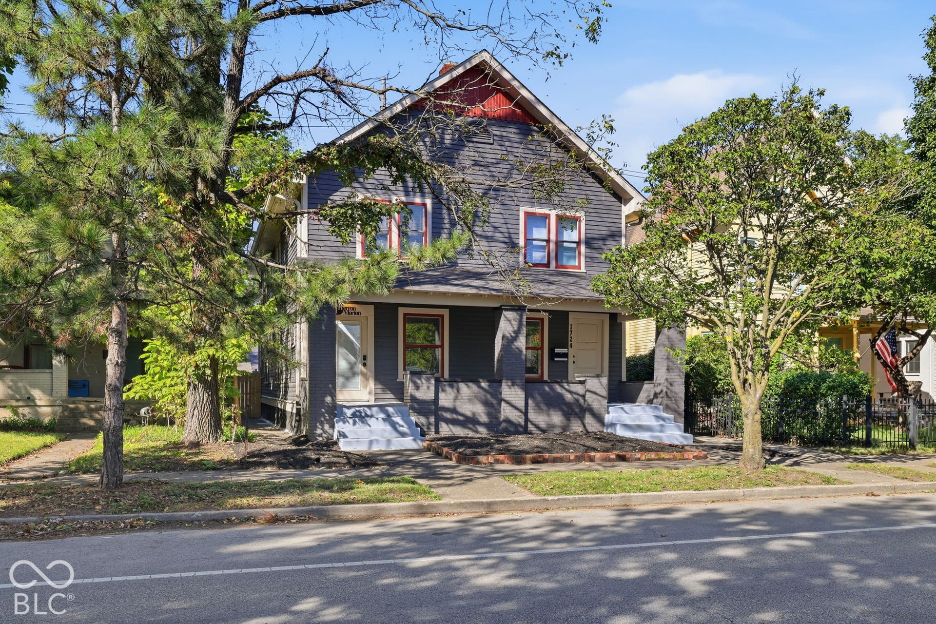 Two-story residence with a gabled roof and gray siding