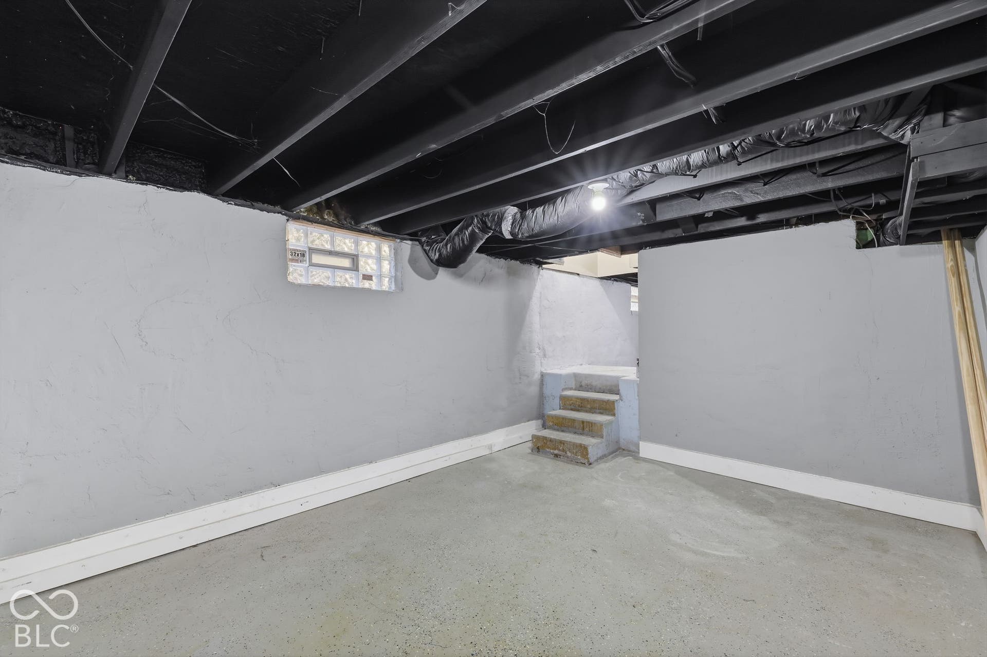 Concrete flooring with light gray painted walls