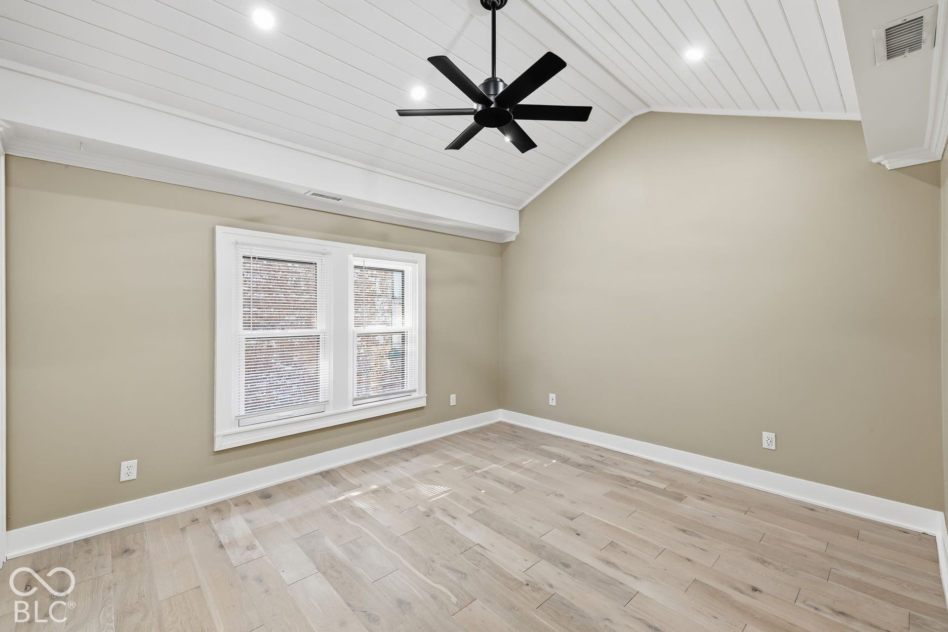 Vaulted ceiling with white plank finish, recessed lighting, and a black ceiling fan