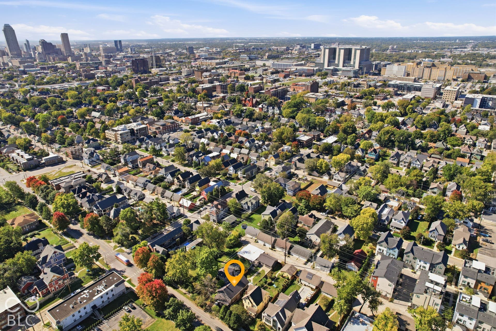 Aerial perspective showcasing a residential neighborhood with a distant cityscape