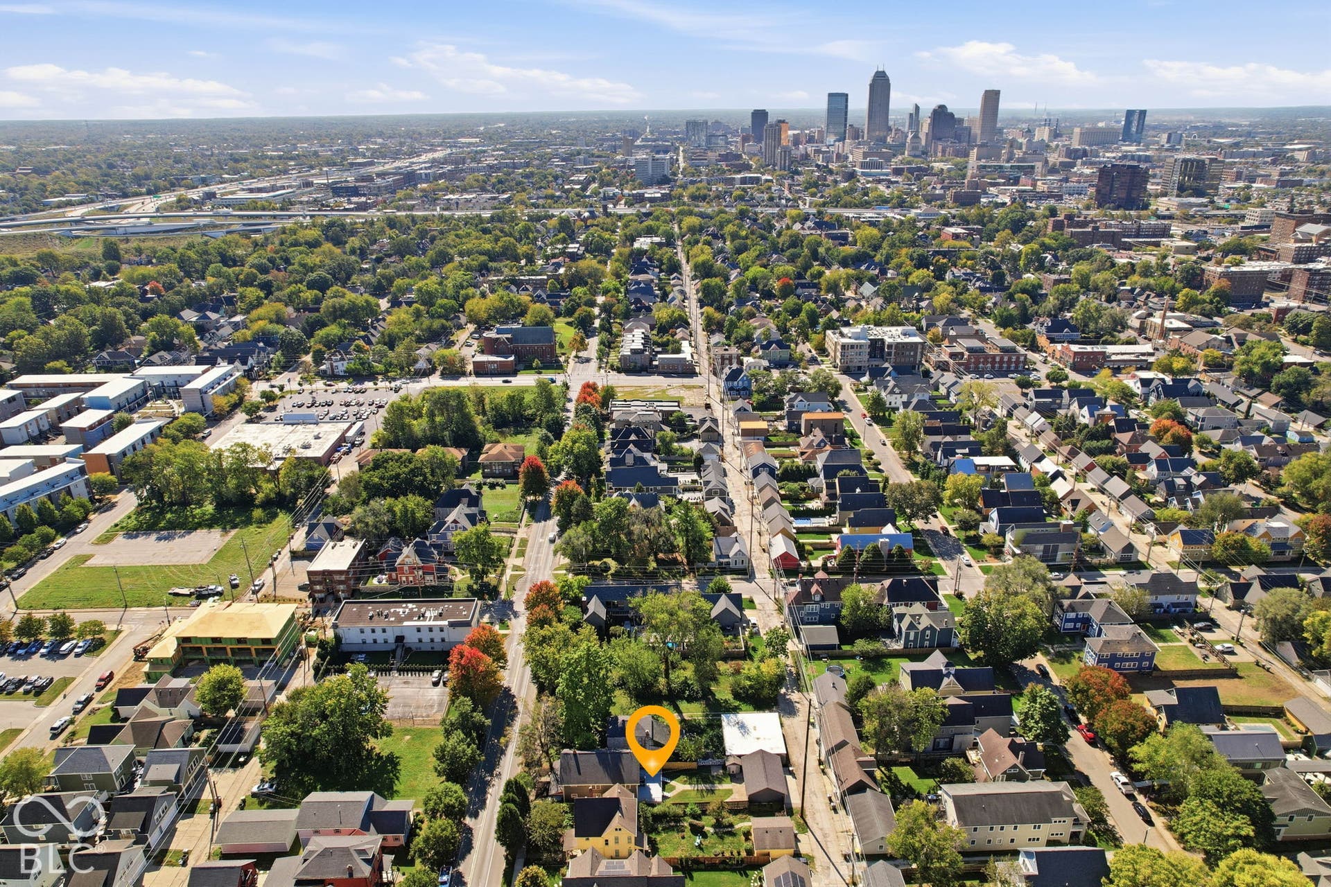 Expansive urban landscape featuring a dense network of residential streets and a vibrant city skyline