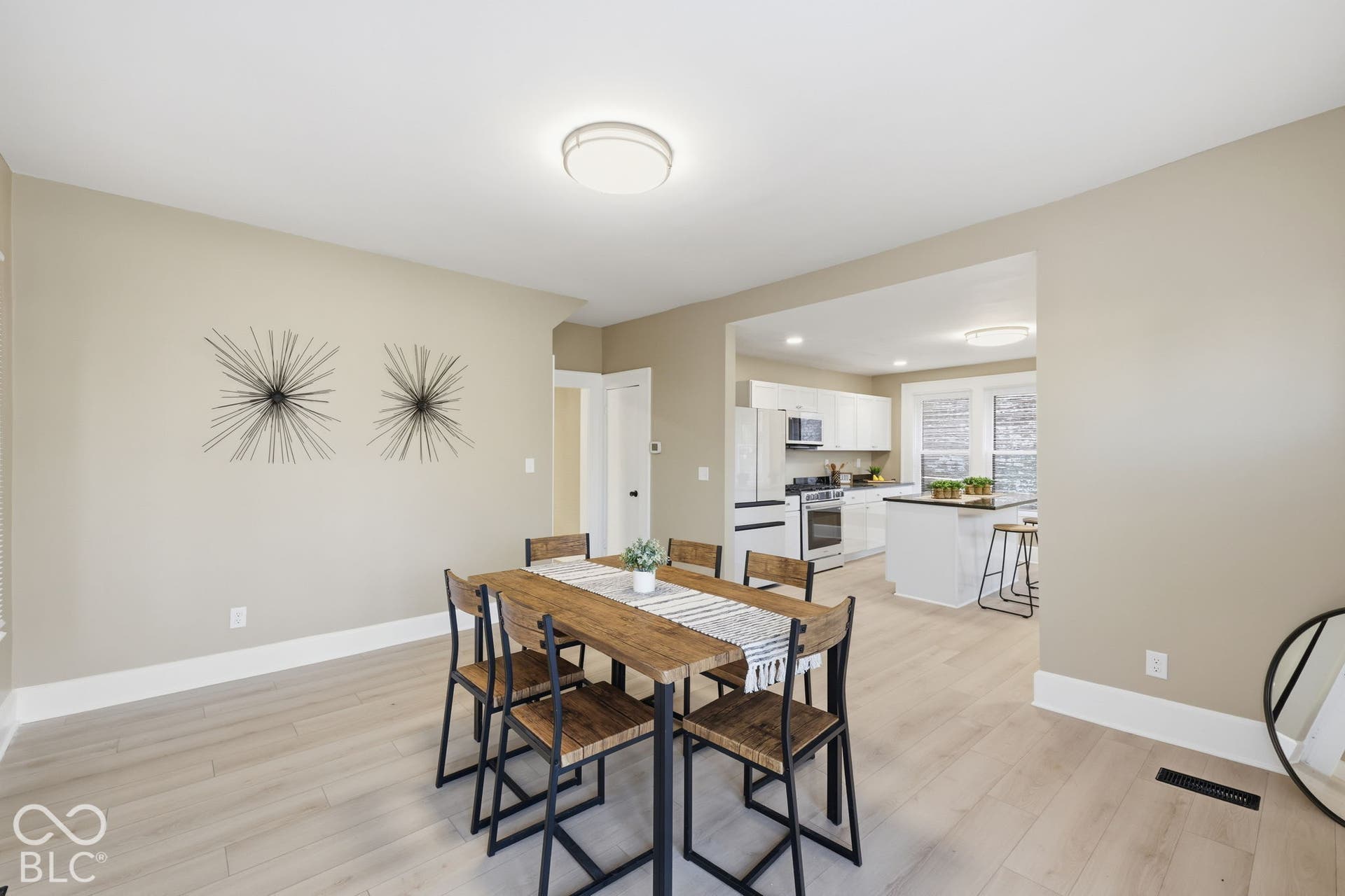 Open-concept living space with light-toned wood-finish flooring