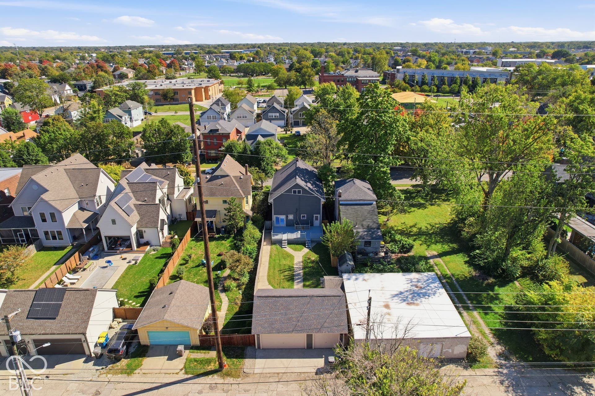 Single-family residence with a gray exterior, a detached garage, and a fenced backyard